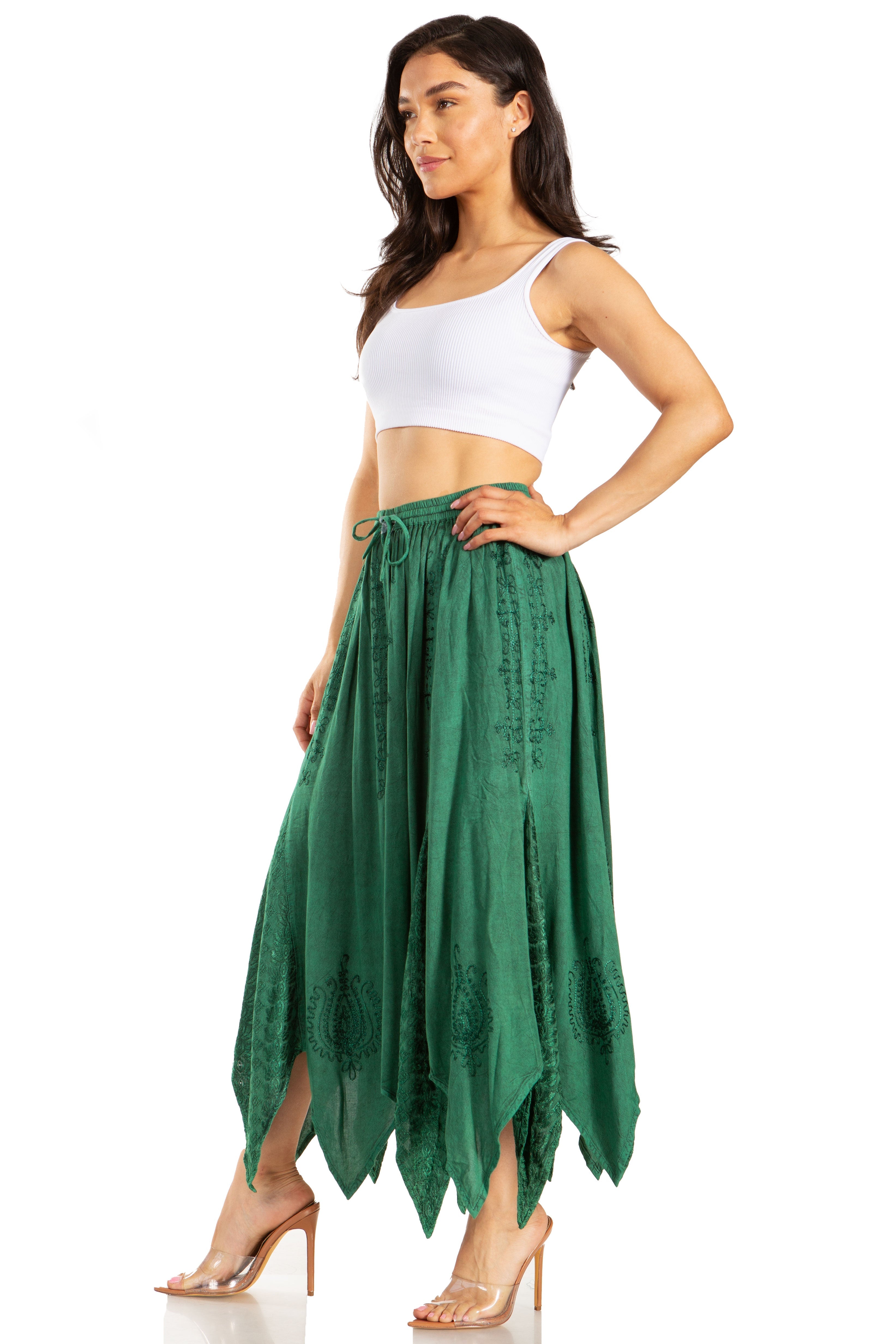 Woman wearing a green skirt and white top on a white background