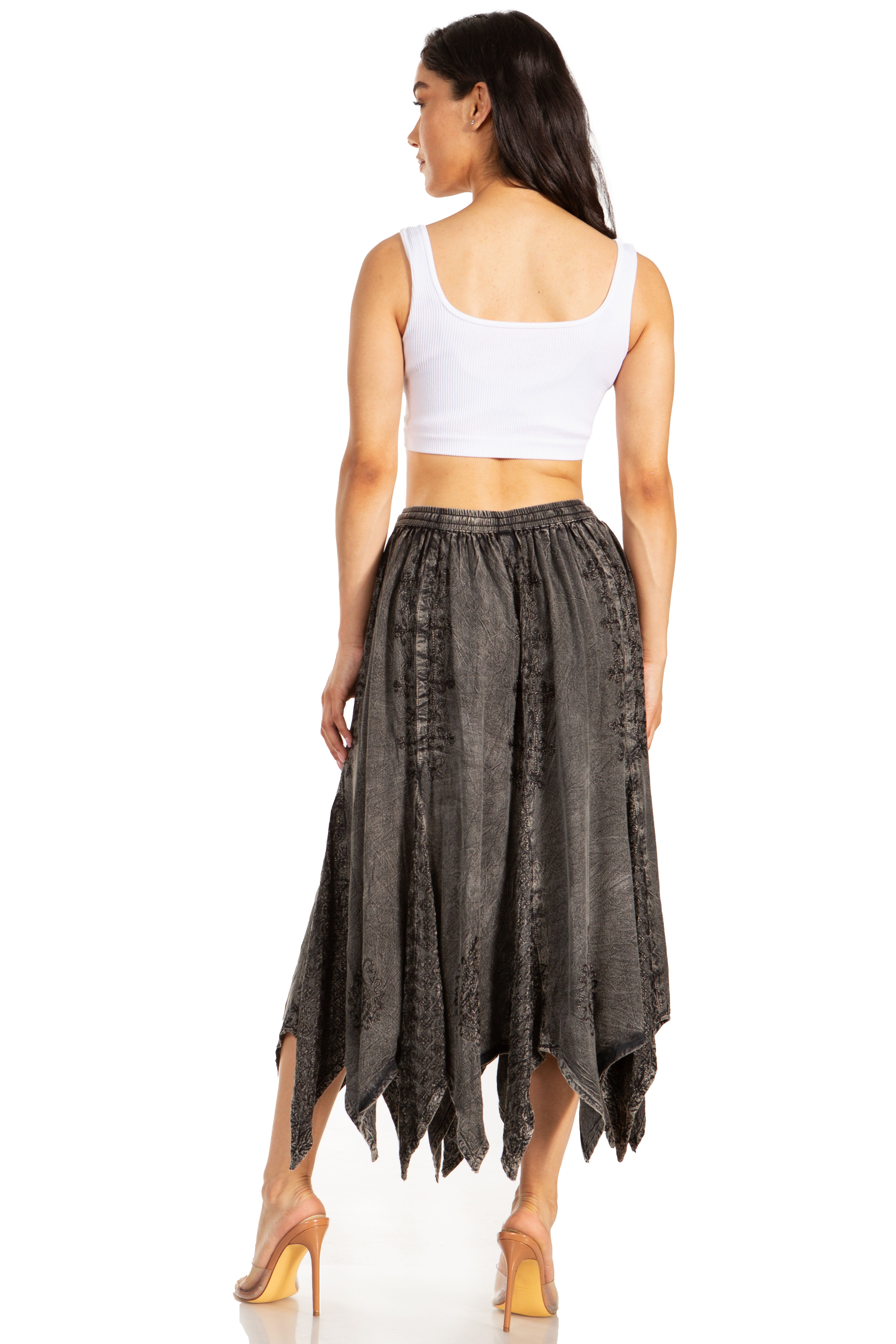 Woman wearing a white top and dark gray skirt on a white background