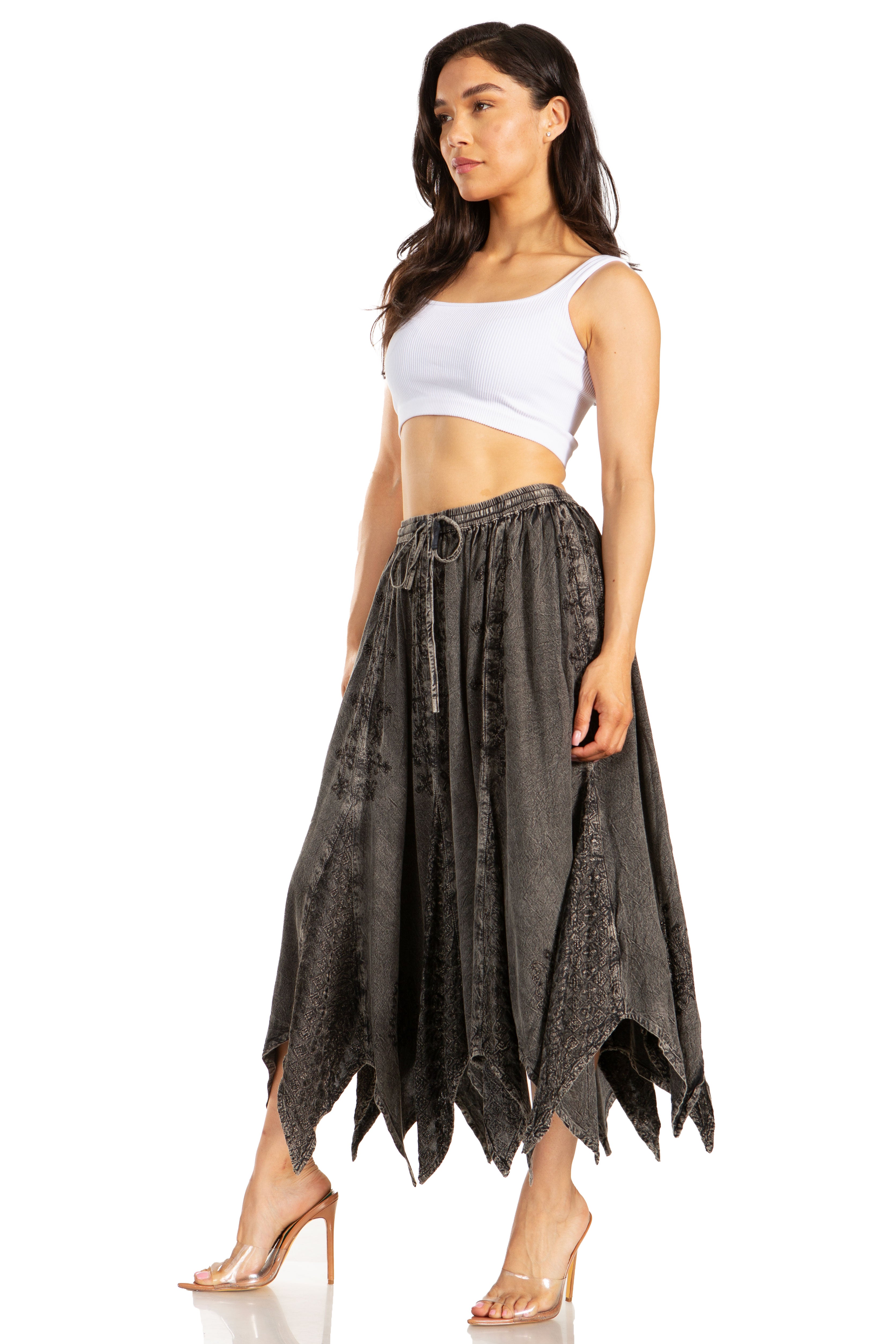 Woman wearing a white top and dark patterned skirt on a white background