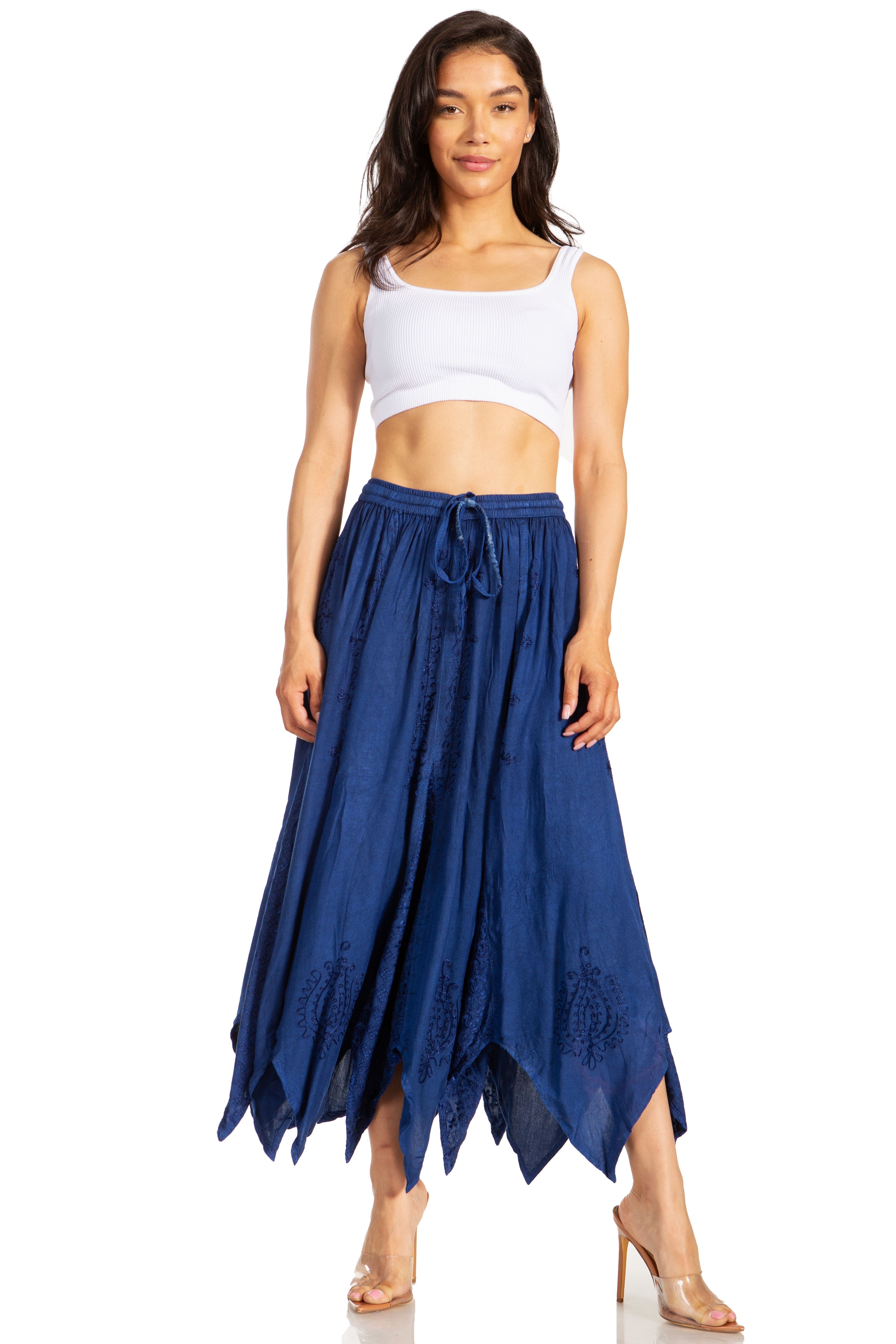 Woman wearing a white crop top and blue skirt on a white background