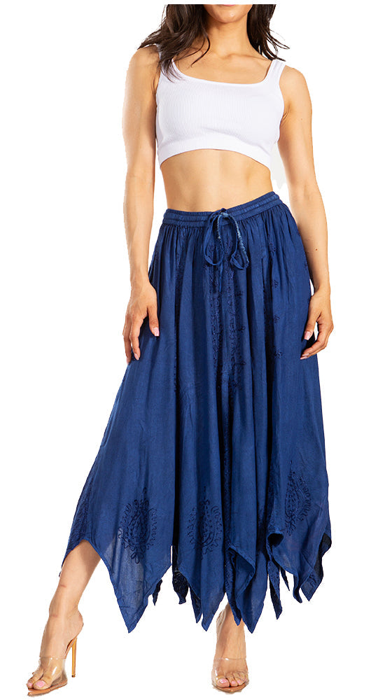 Woman wearing a white crop top and blue flowing skirt on a white background