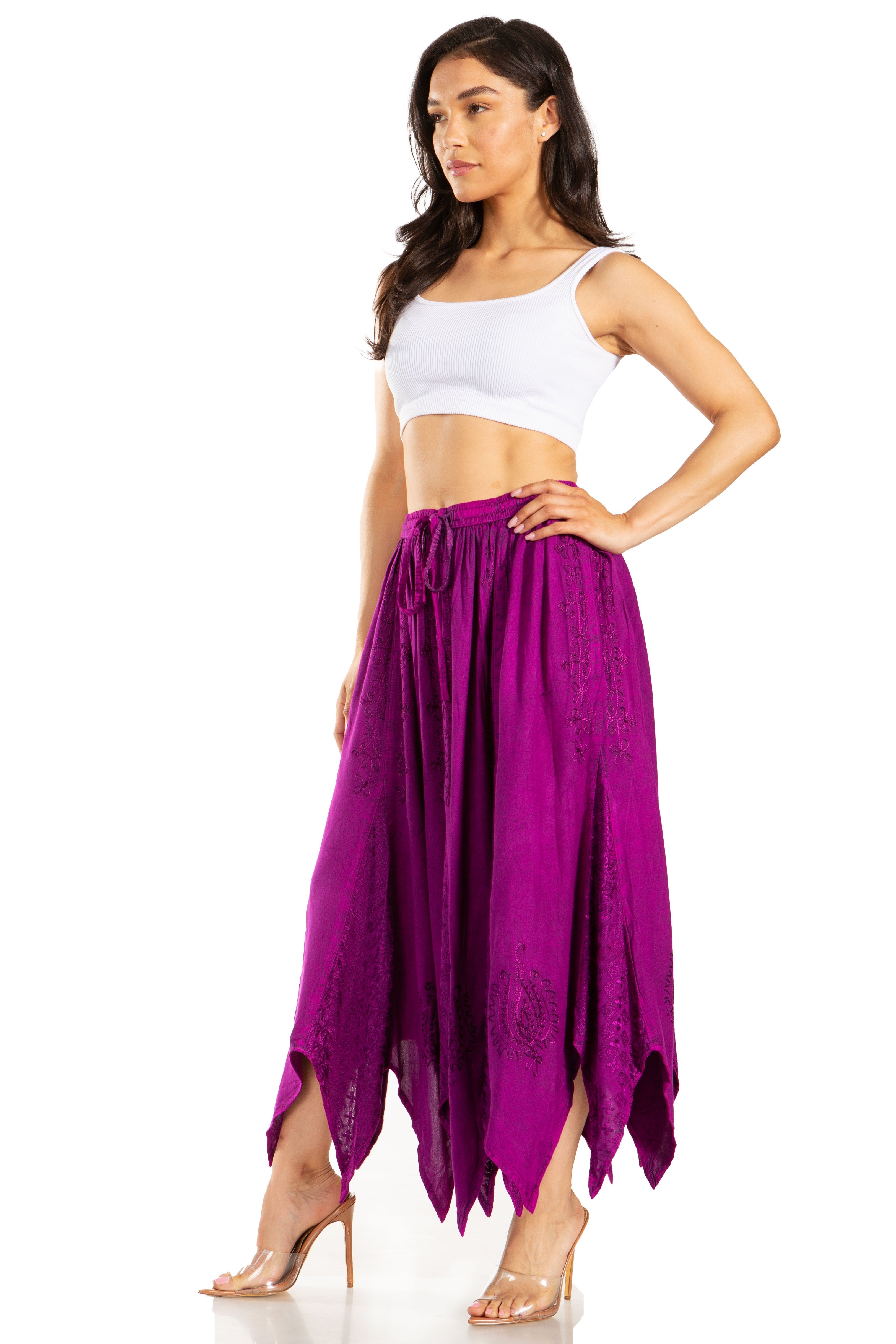 Woman wearing a white top and purple skirt on a white background