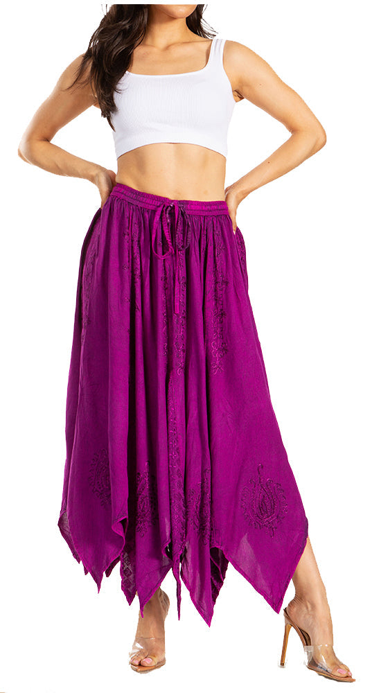 Woman wearing a white top and purple flowing pants on a white background