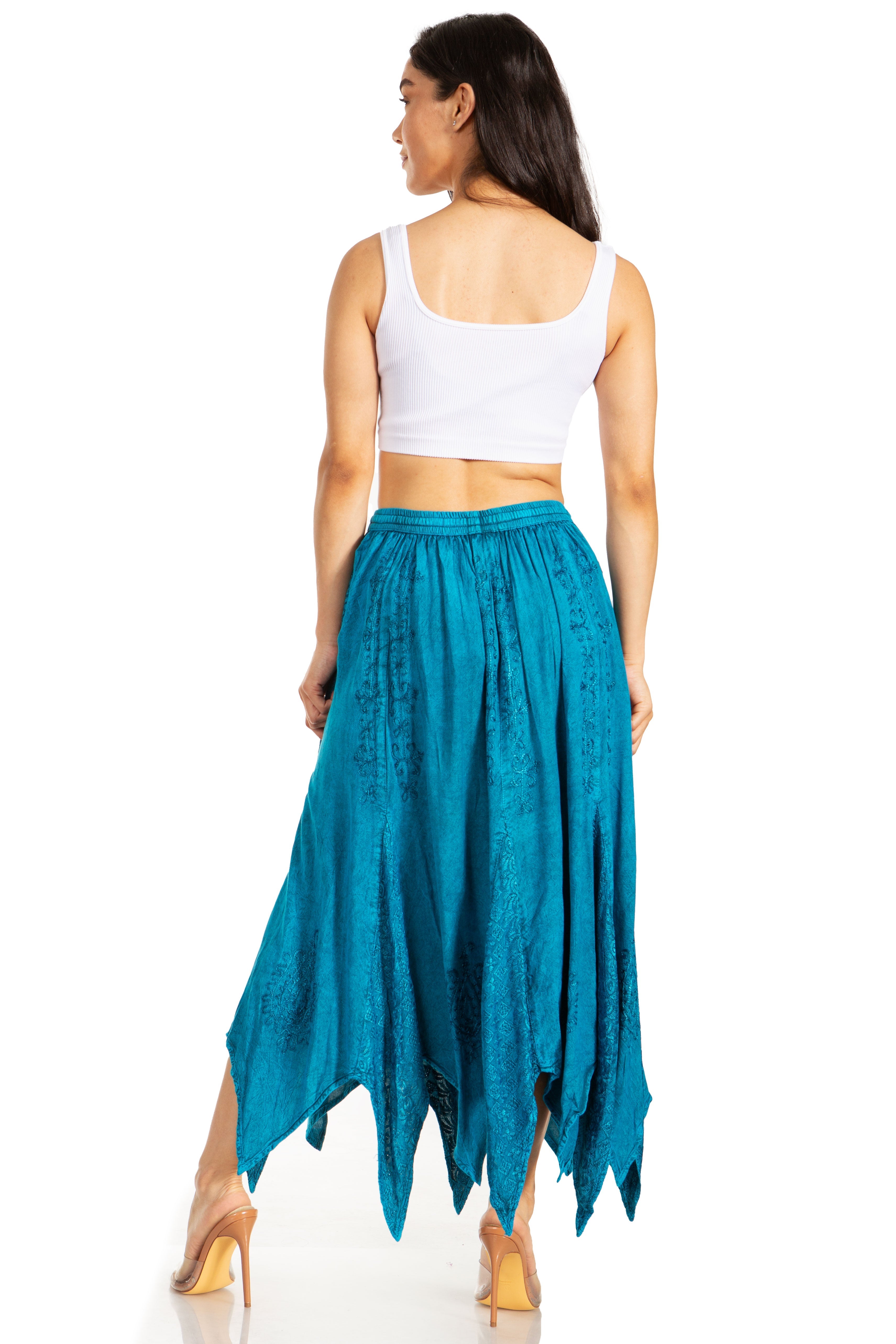 Woman wearing a white top and teal skirt on a white background