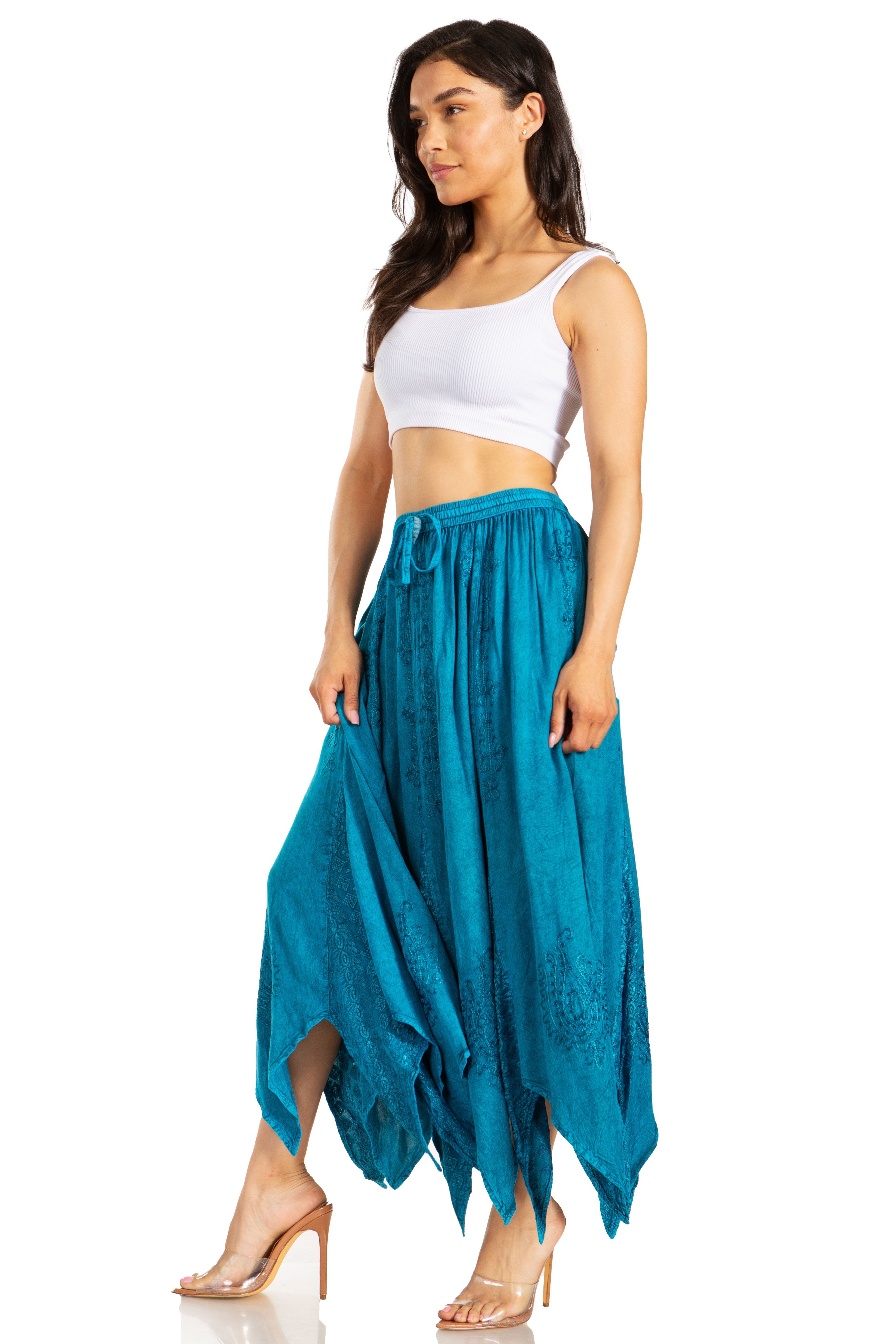 Woman wearing a white top and blue skirt on a white background