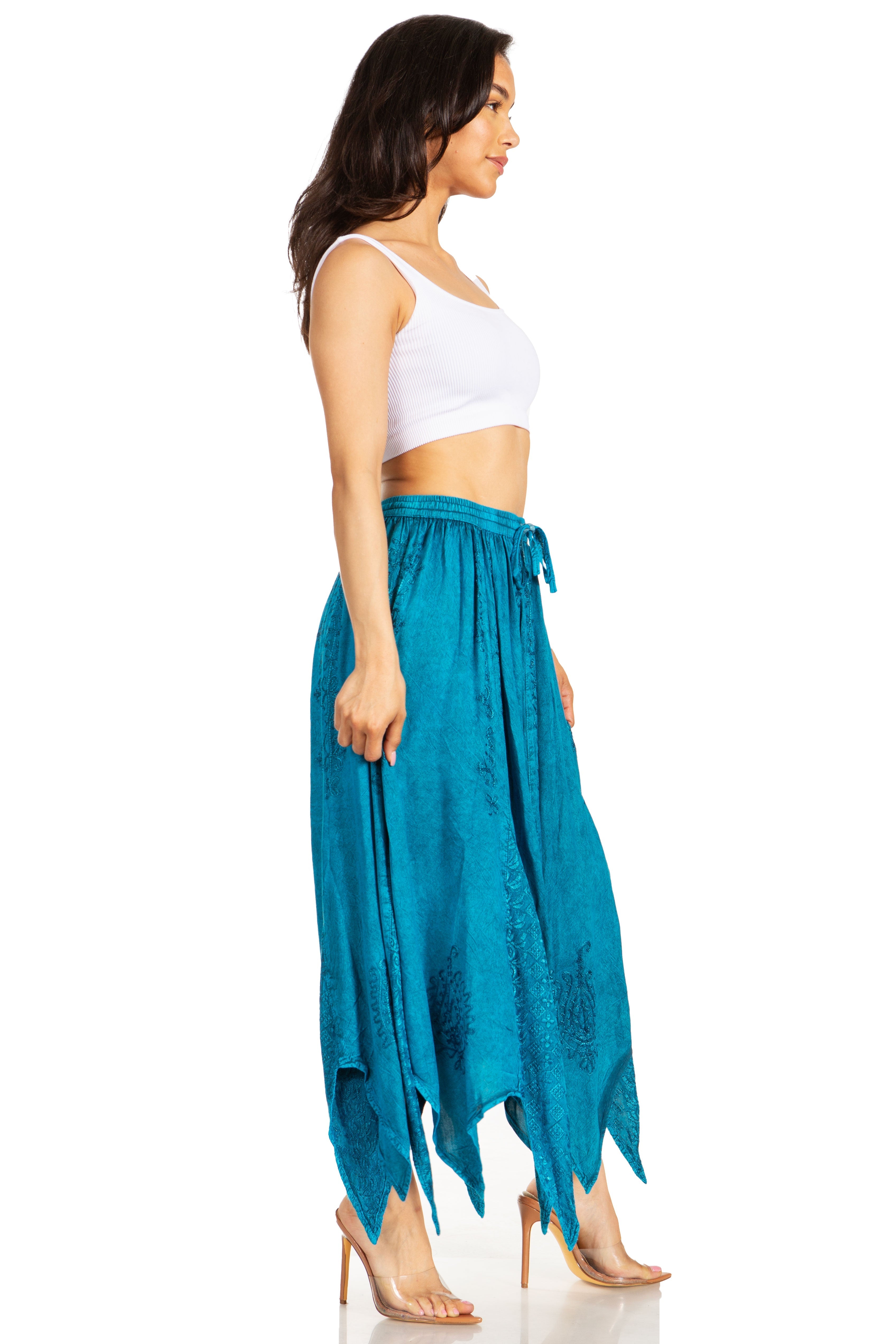 Woman wearing a white top and teal skirt on a white background