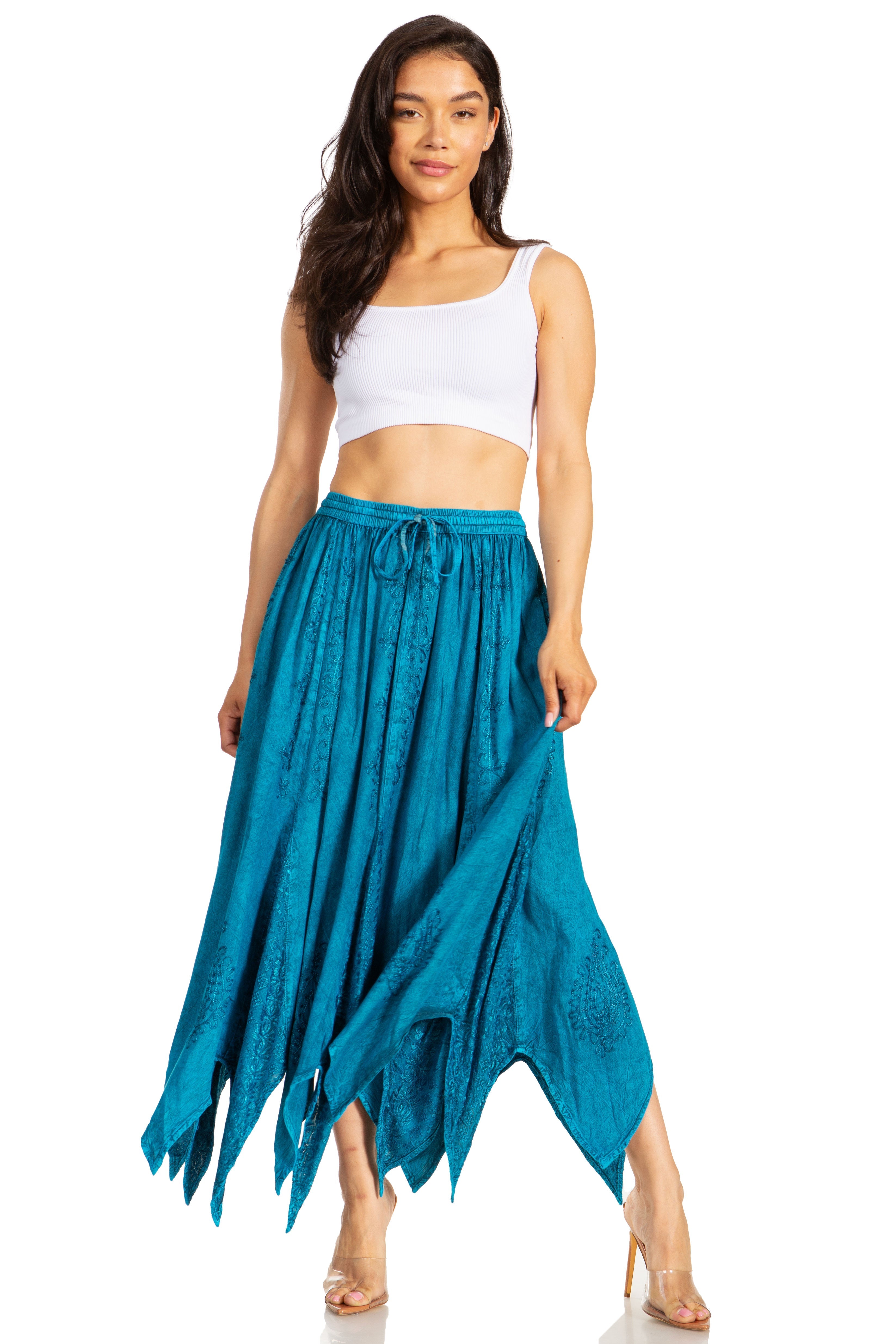 Woman wearing a white top and teal skirt on a white background