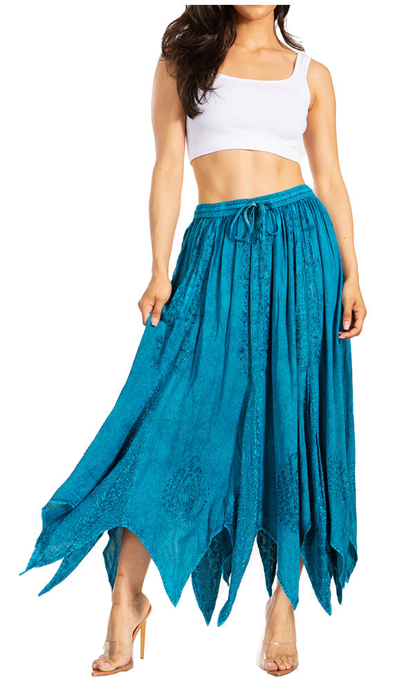 Woman wearing a white crop top and blue flowing skirt on a white background