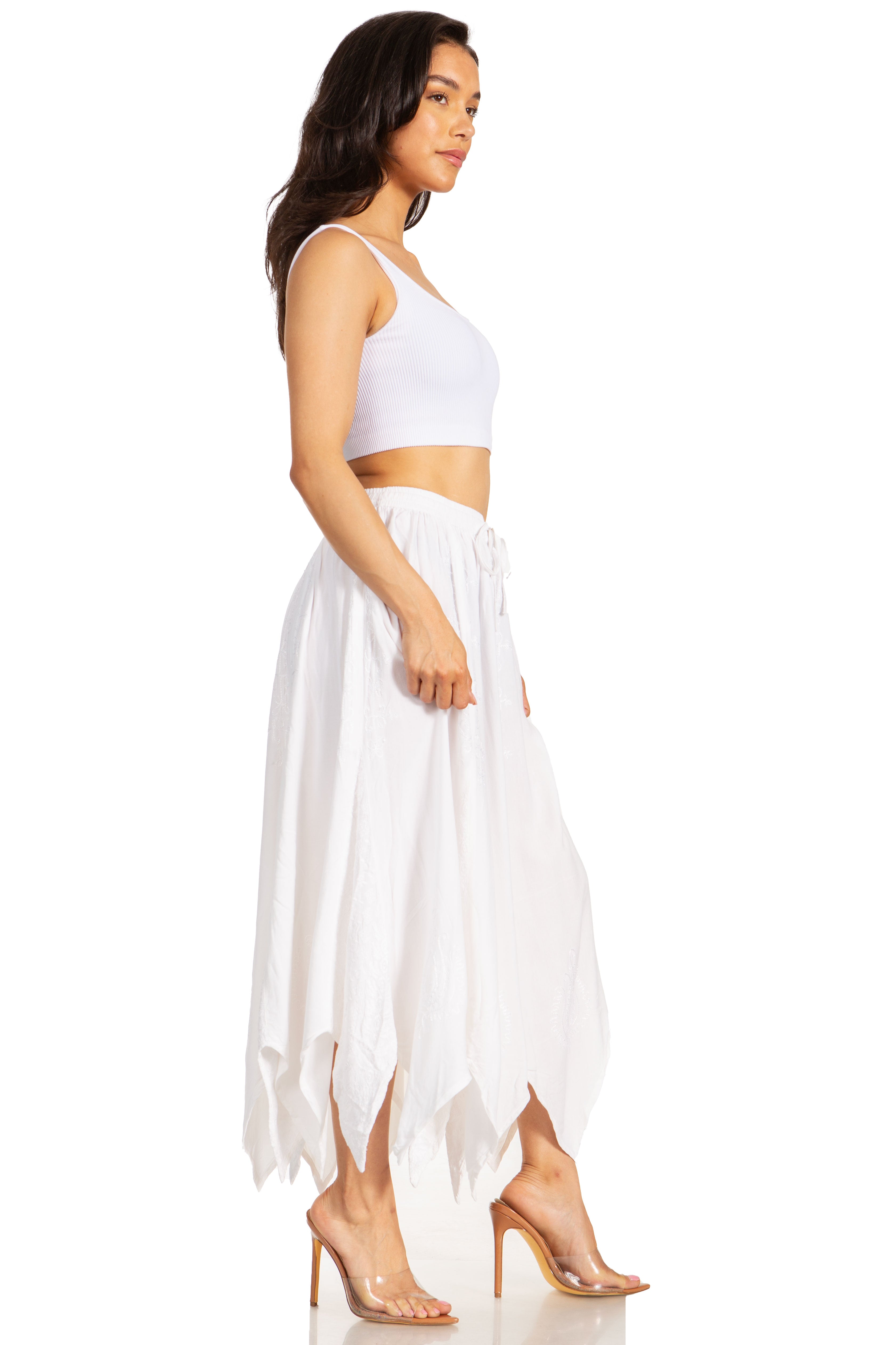 Woman wearing a white top and flowing white skirt on a white background