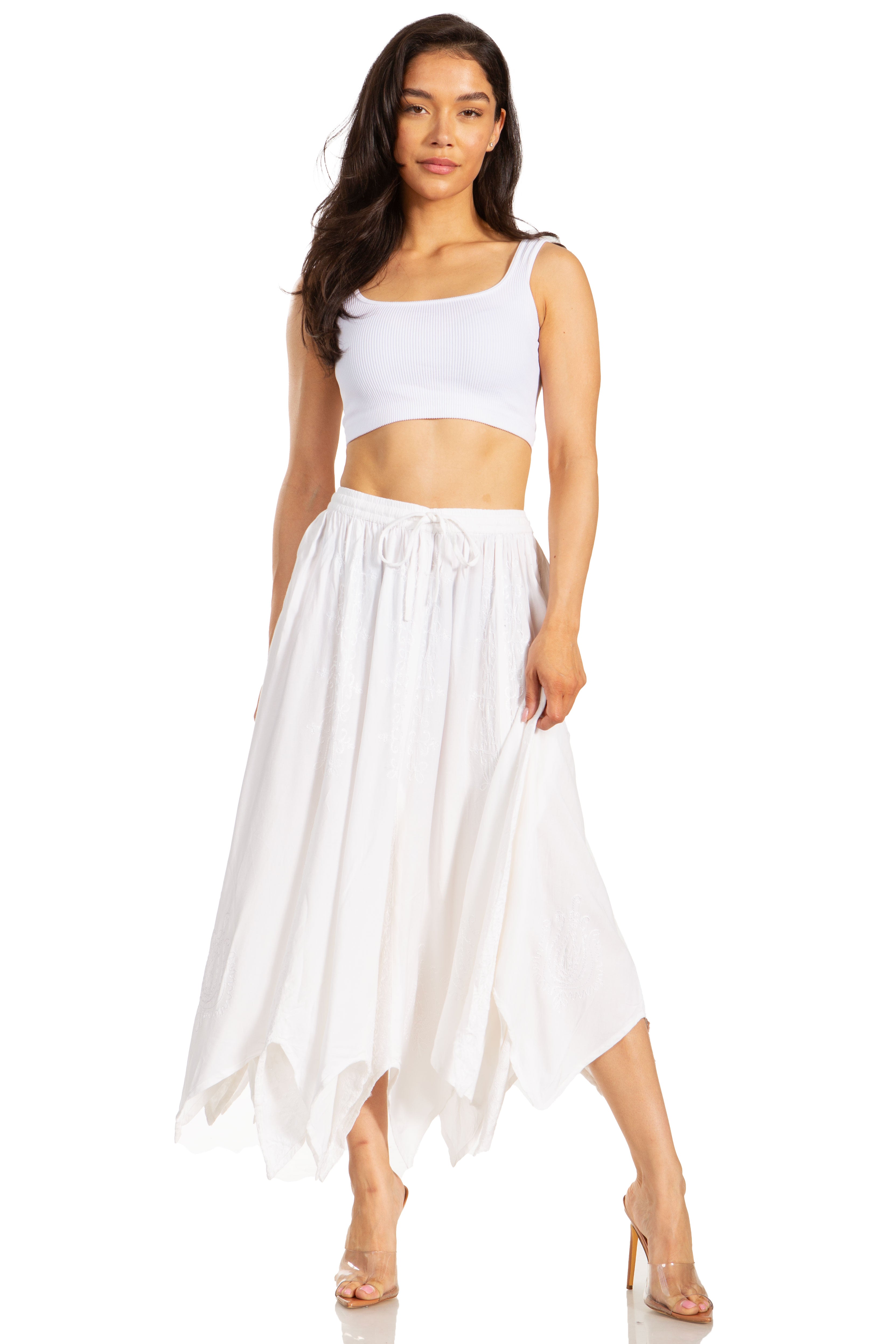Woman wearing a white top and long white skirt on a white background