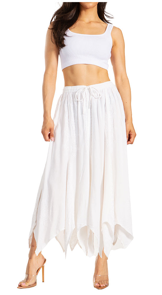 Woman wearing a white crop top and long skirt on a white background
