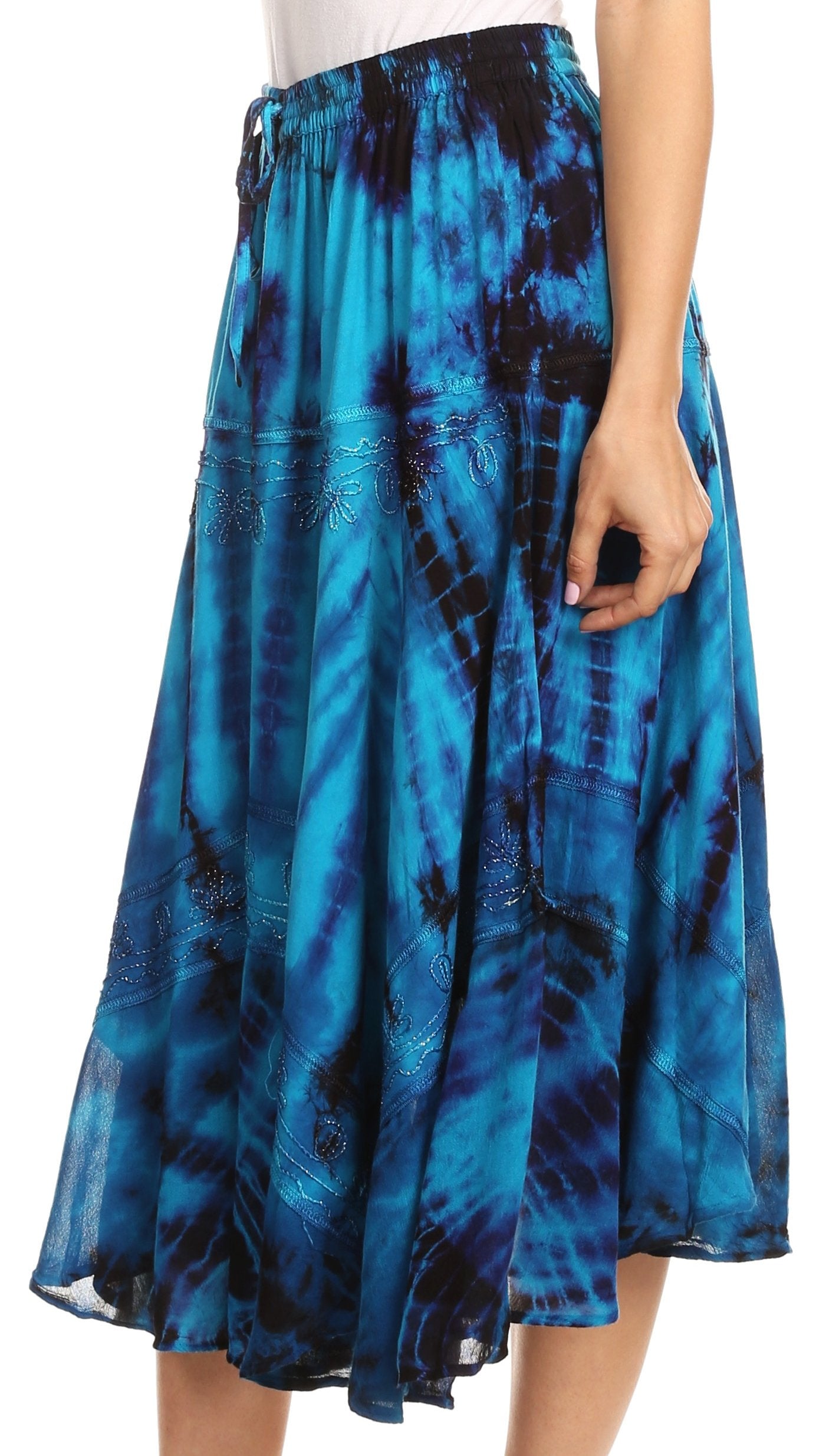 Blue tie-dye skirt worn by a person on a white background