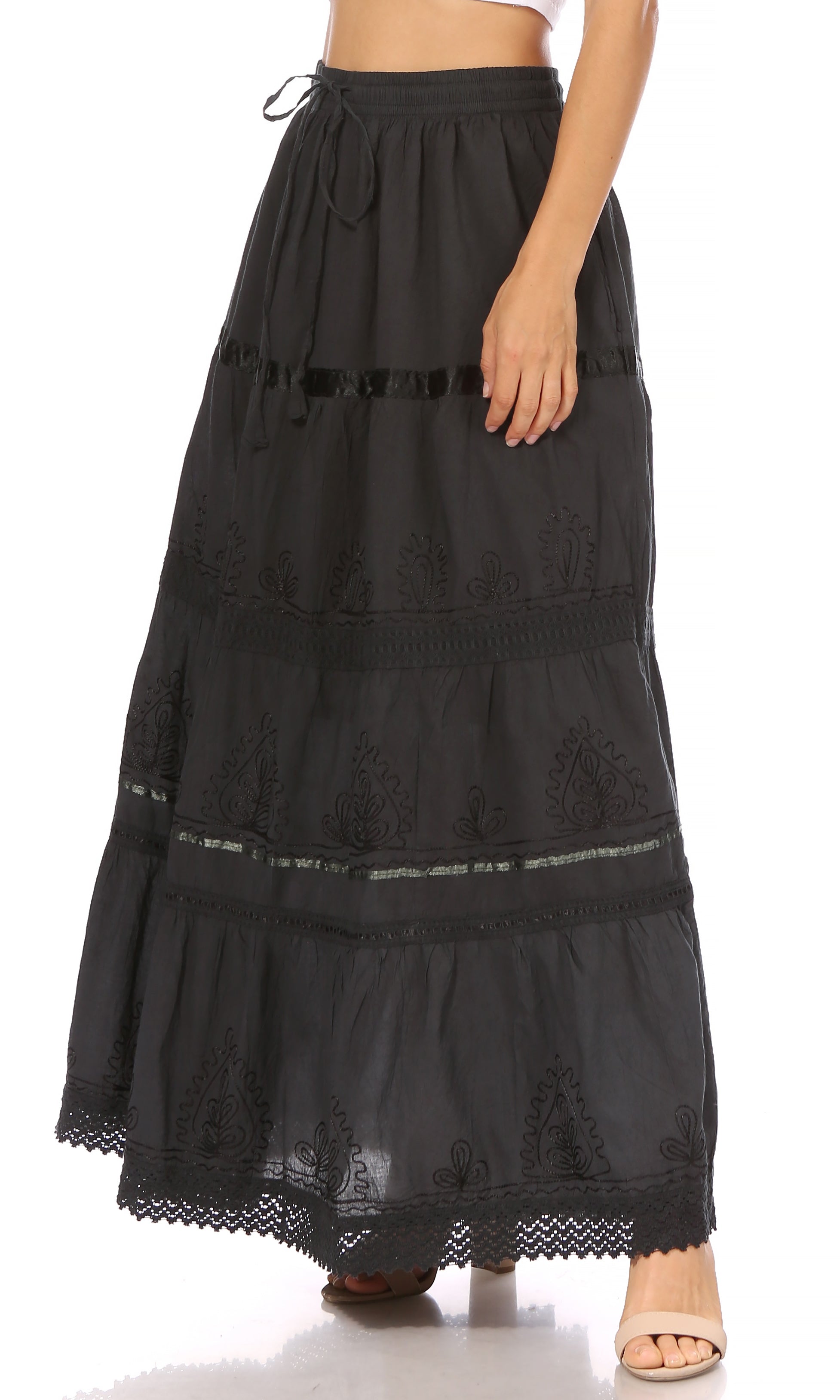 Black lace-trimmed skirt worn by a person on a white background