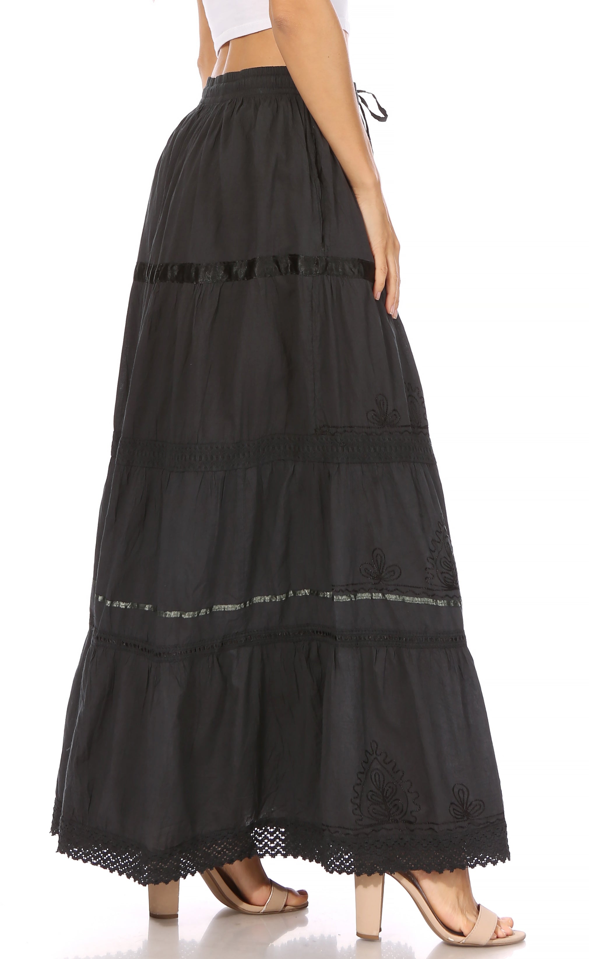 Black tiered maxi skirt with lace details on a white background