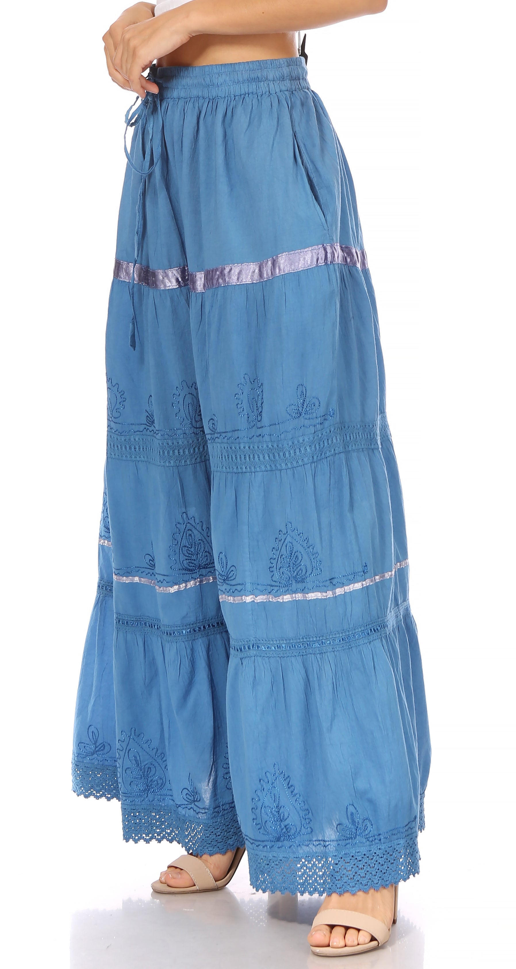 Blue tiered pants with lace details on a white background