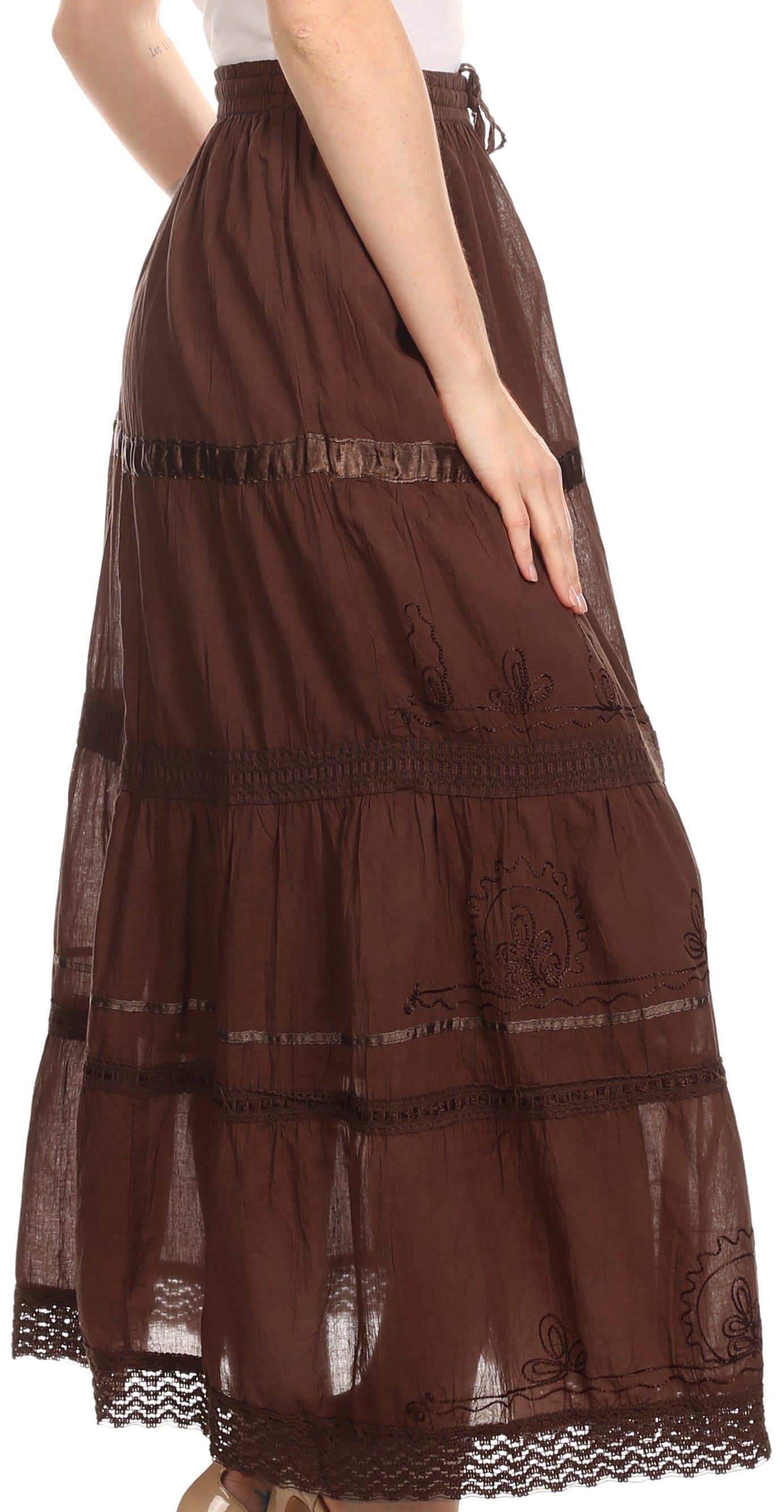 Brown lace skirt worn by a person on a white background