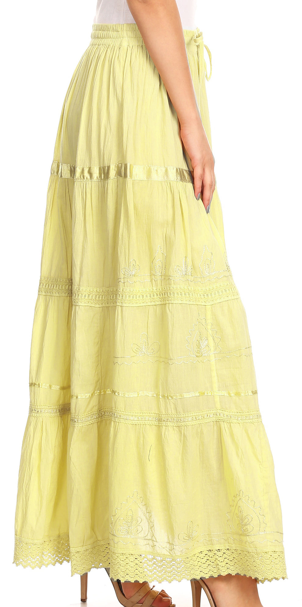 Yellow lace skirt worn by a person on a white background