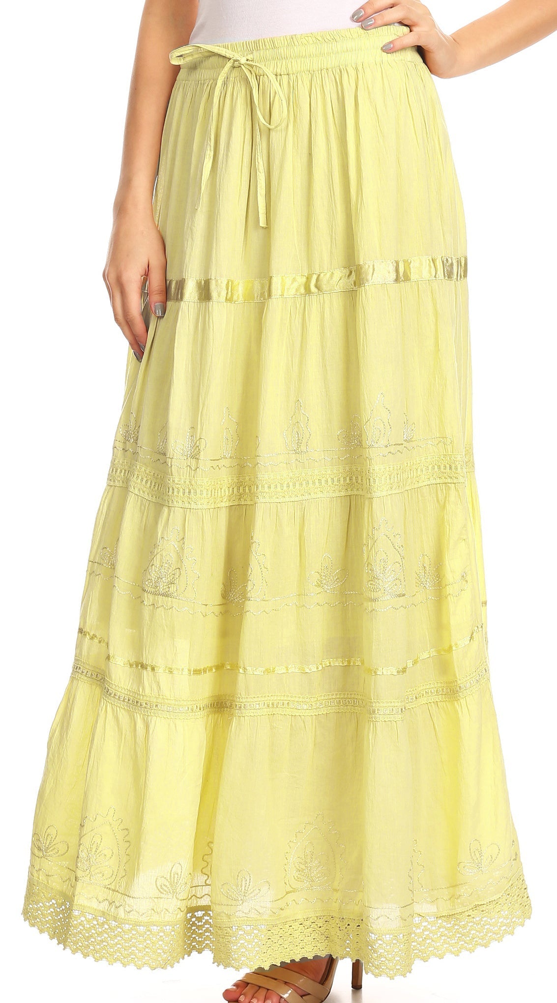 Yellow lace skirt worn by a person on a white background