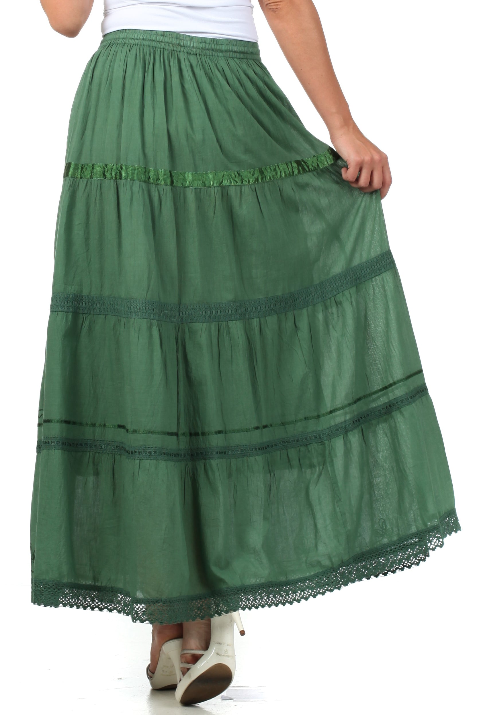 Green tiered skirt worn by a person on a white background