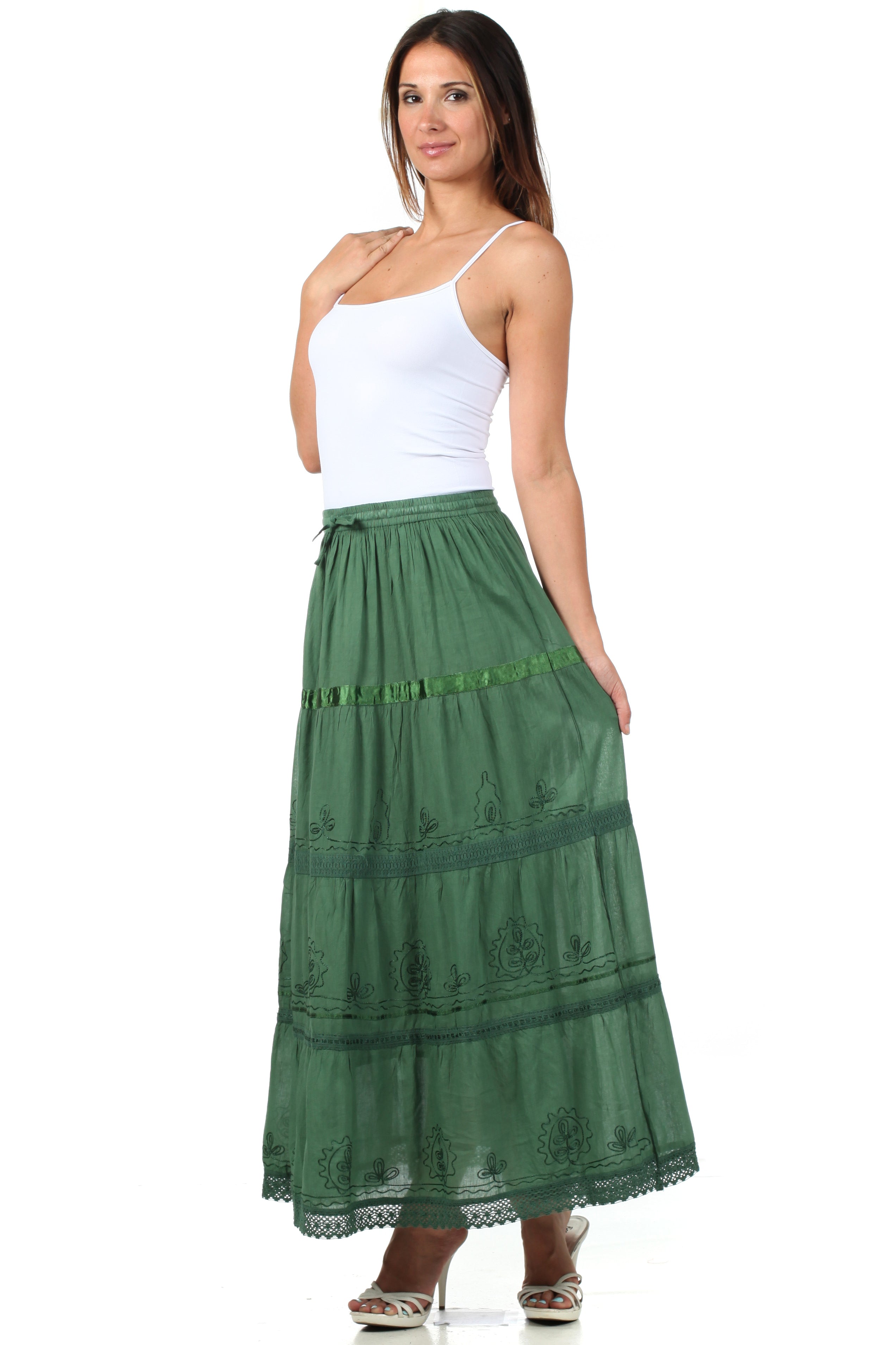 Woman wearing a green skirt and white top on a white background