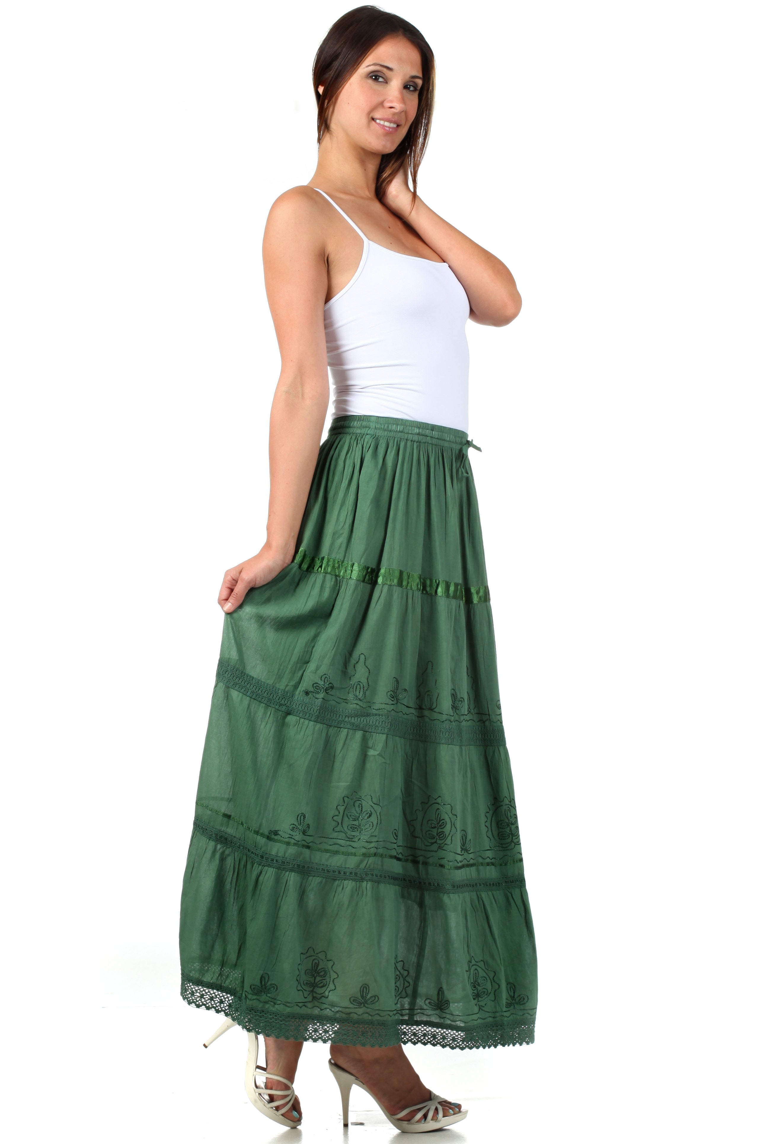 Woman wearing a green skirt and white top on a white background