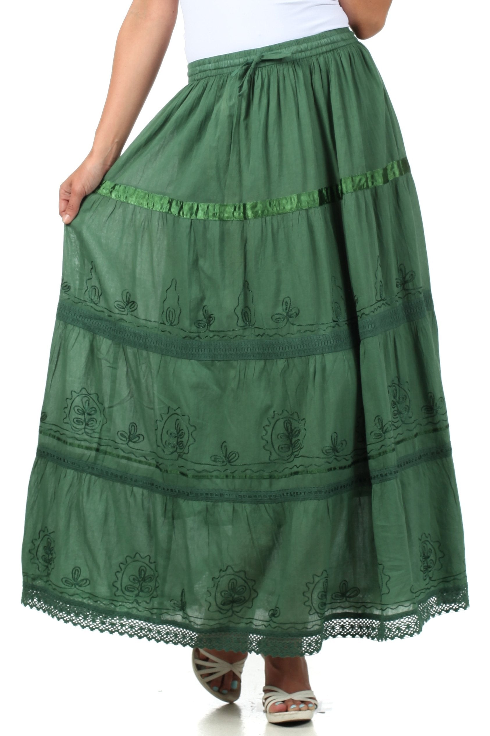 Green embroidered skirt worn by a person on a white background
