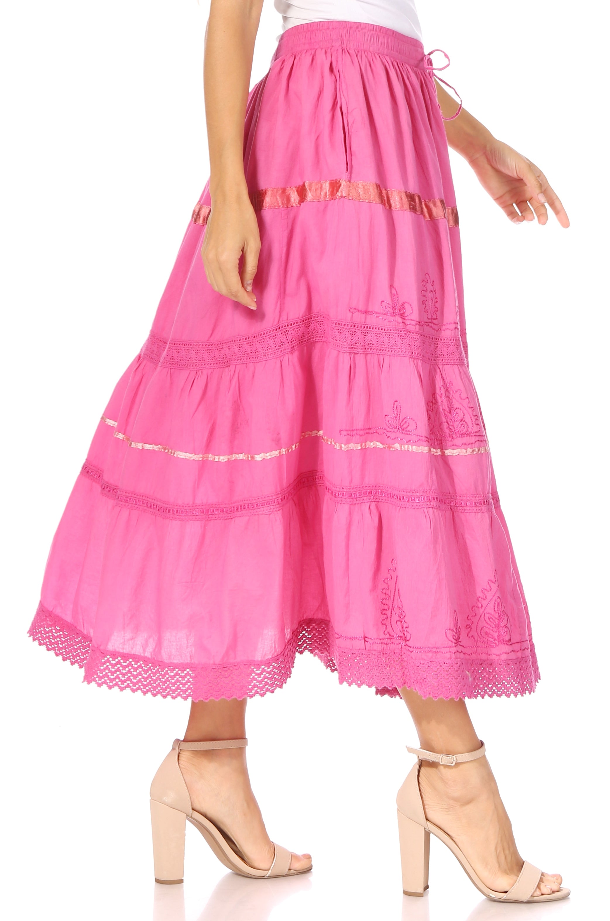 Pink tiered skirt worn by a person on a white background