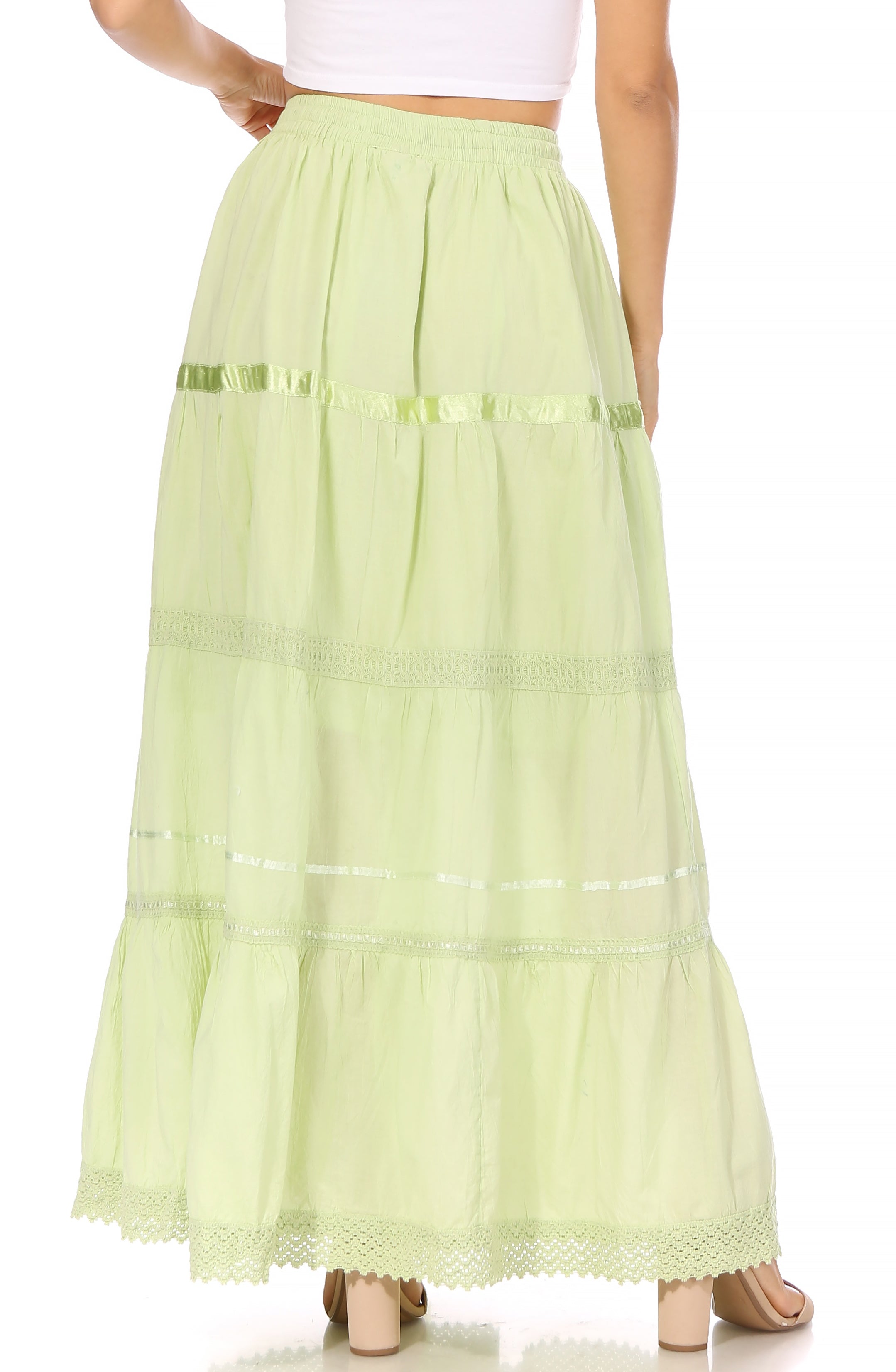 Light green tiered skirt worn by a person on a white background