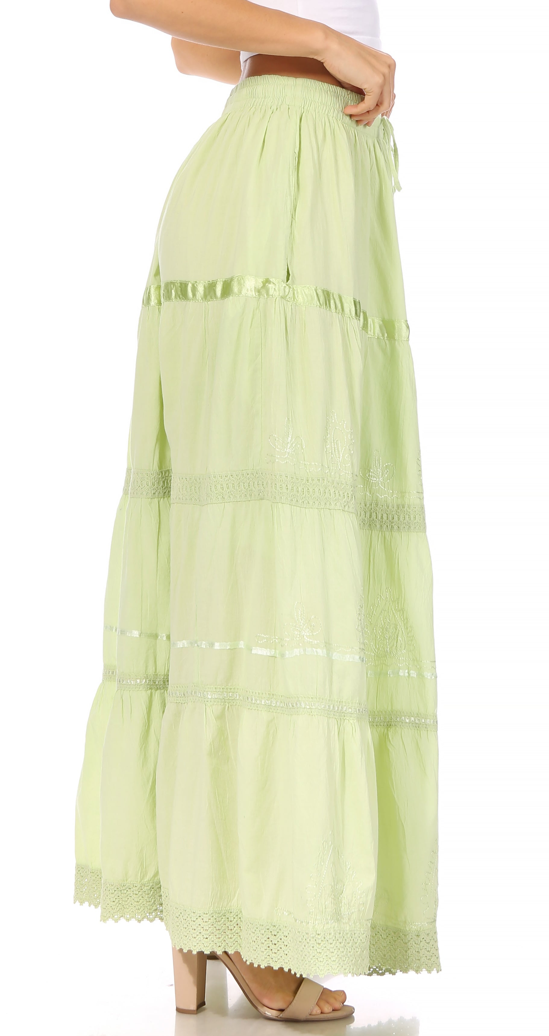 Light green tiered skirt worn by a person on a white background