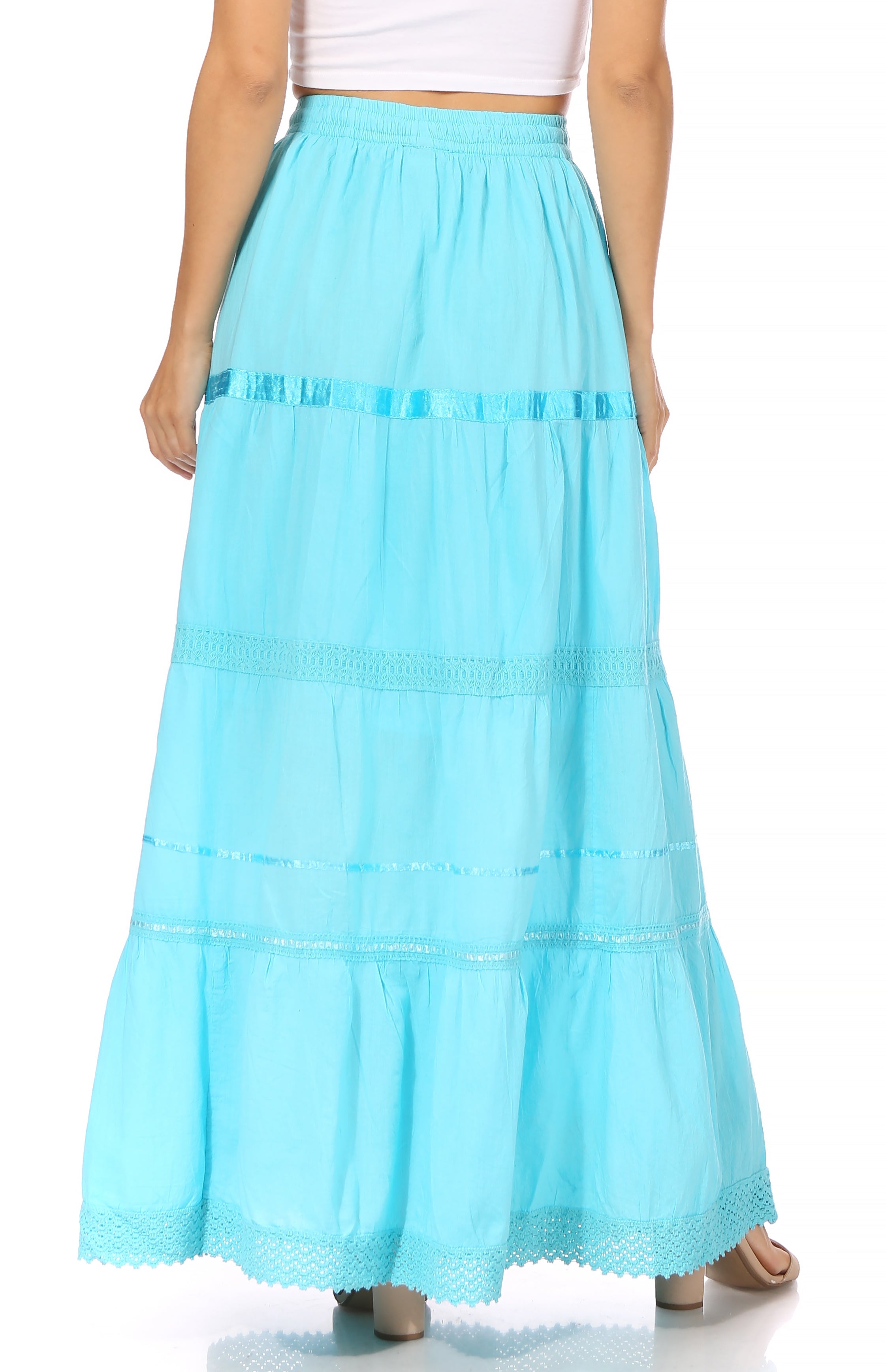 Turquoise layered skirt worn by a person on a white background