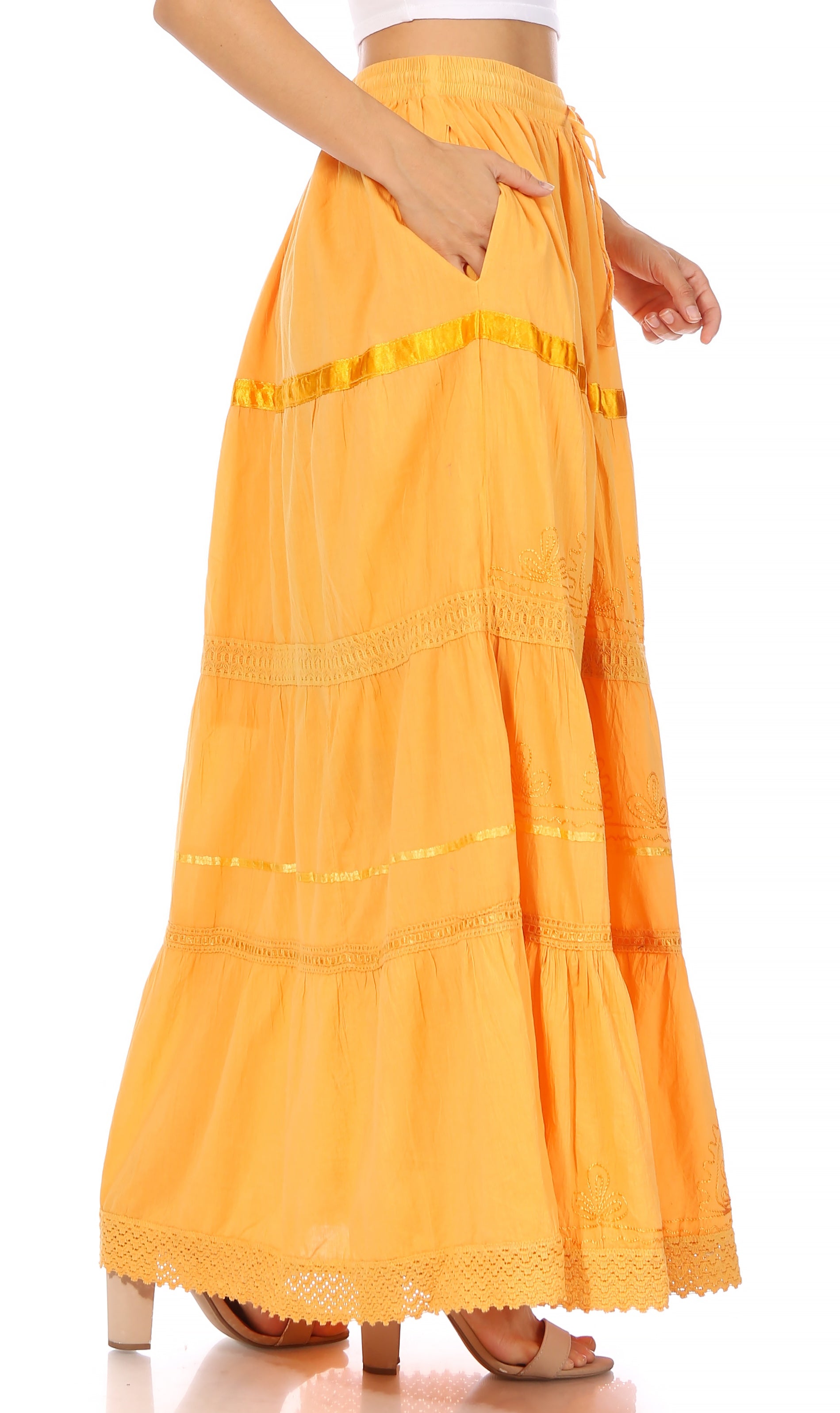 Yellow long skirt with lace details on a white background