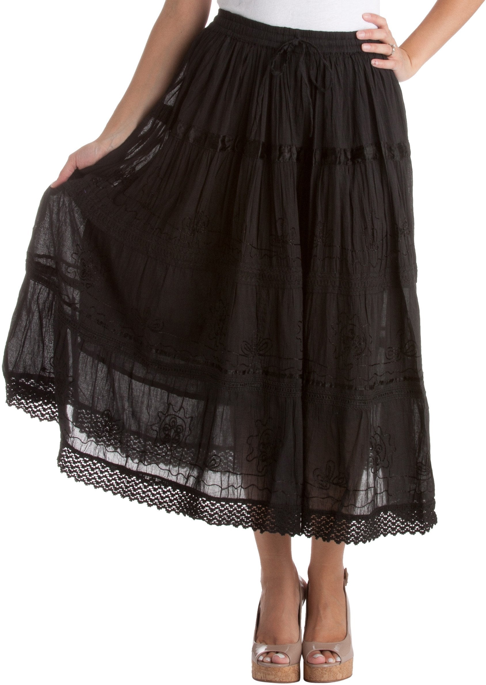 Black lace skirt worn by a person on a white background