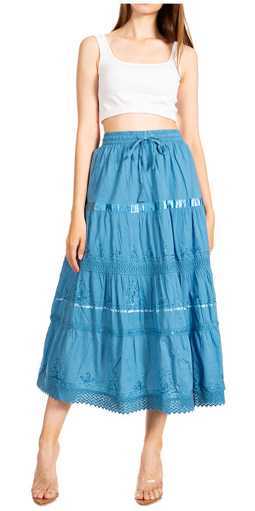 Woman wearing a blue tiered skirt with a white top on a white background