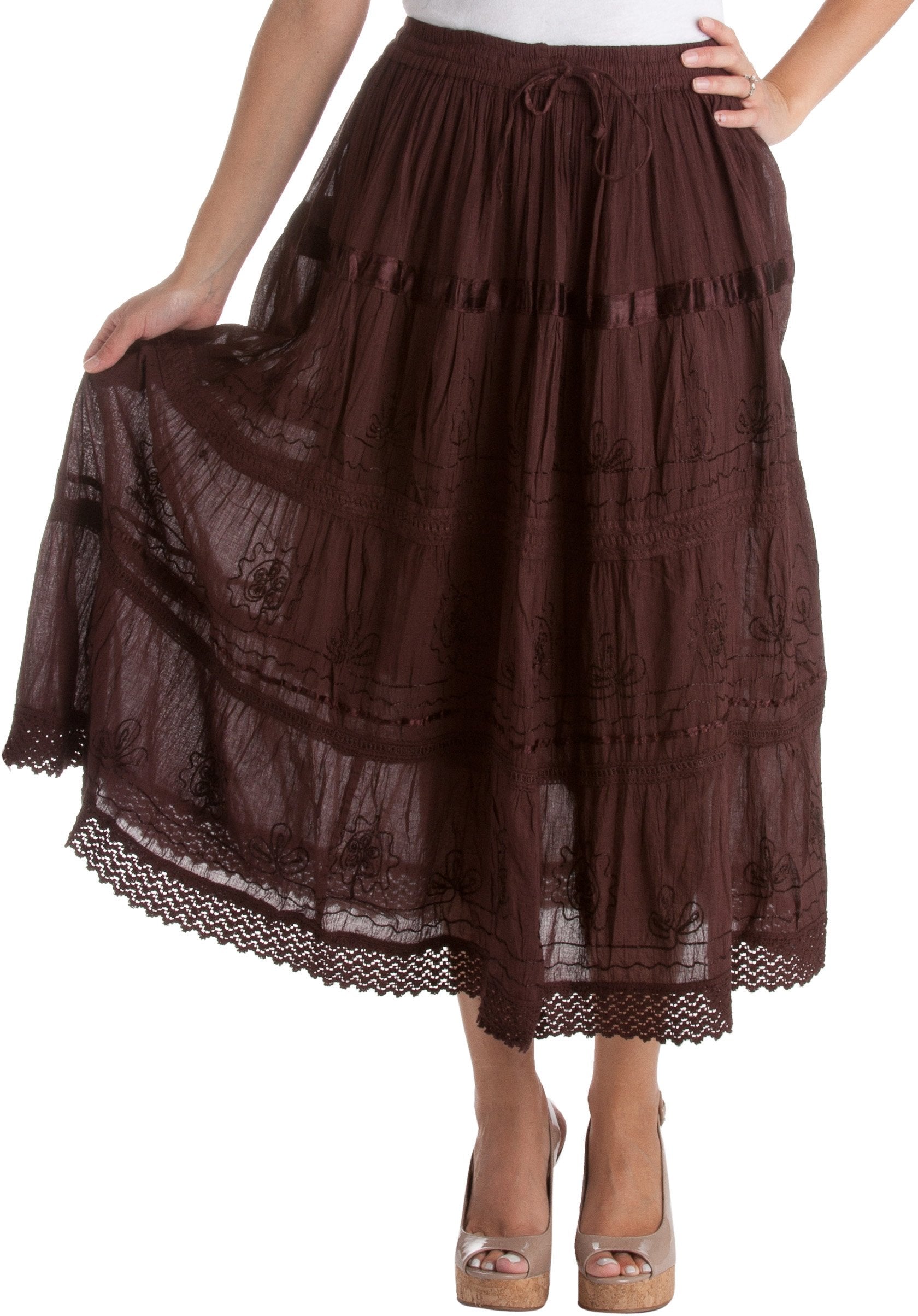 Brown lace skirt worn by a person on a white background