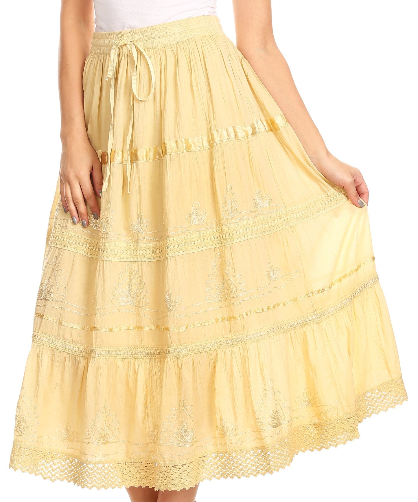 Yellow lace skirt worn by a person on a white background
