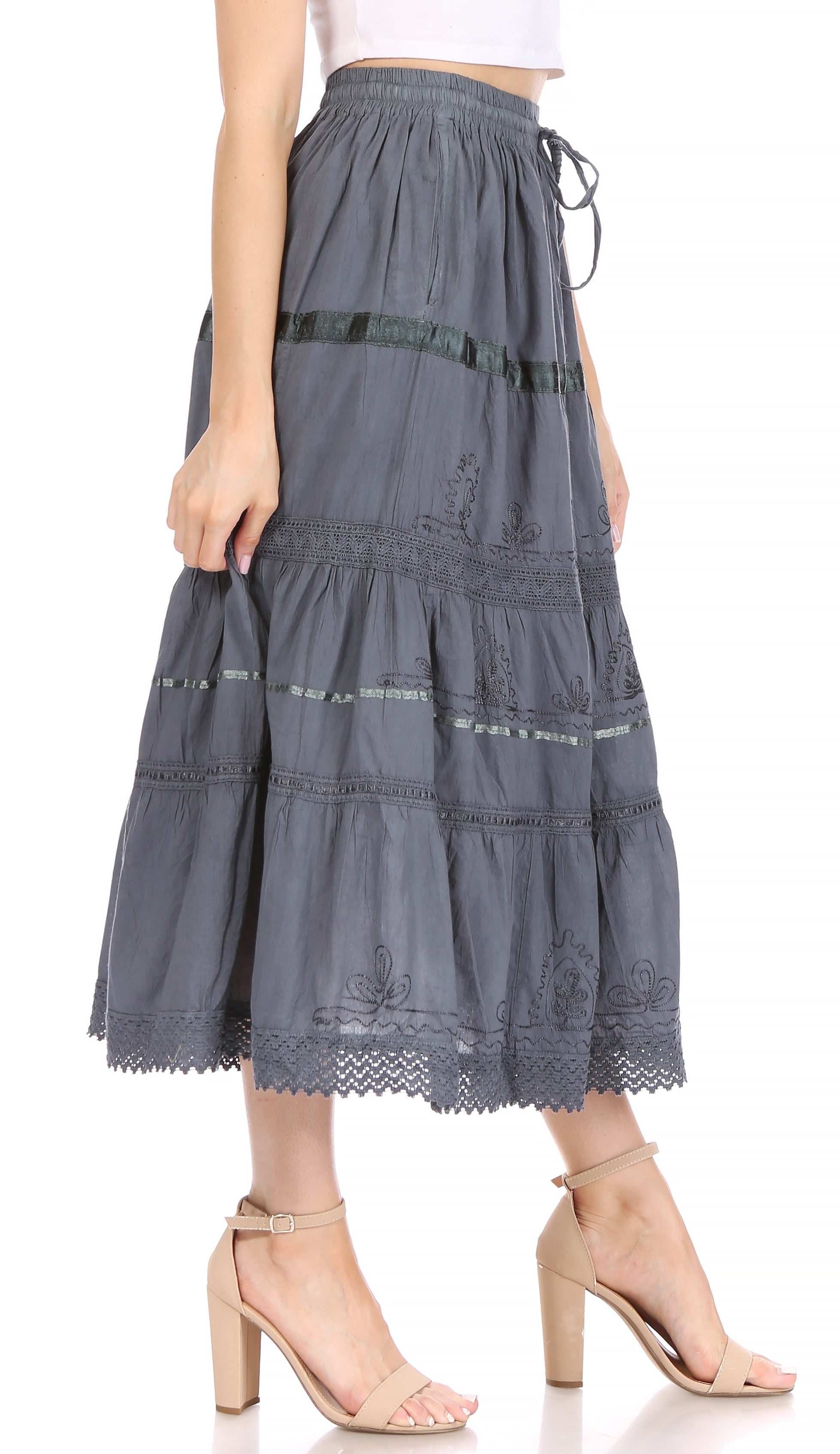Gray tiered skirt worn by a person on a white background