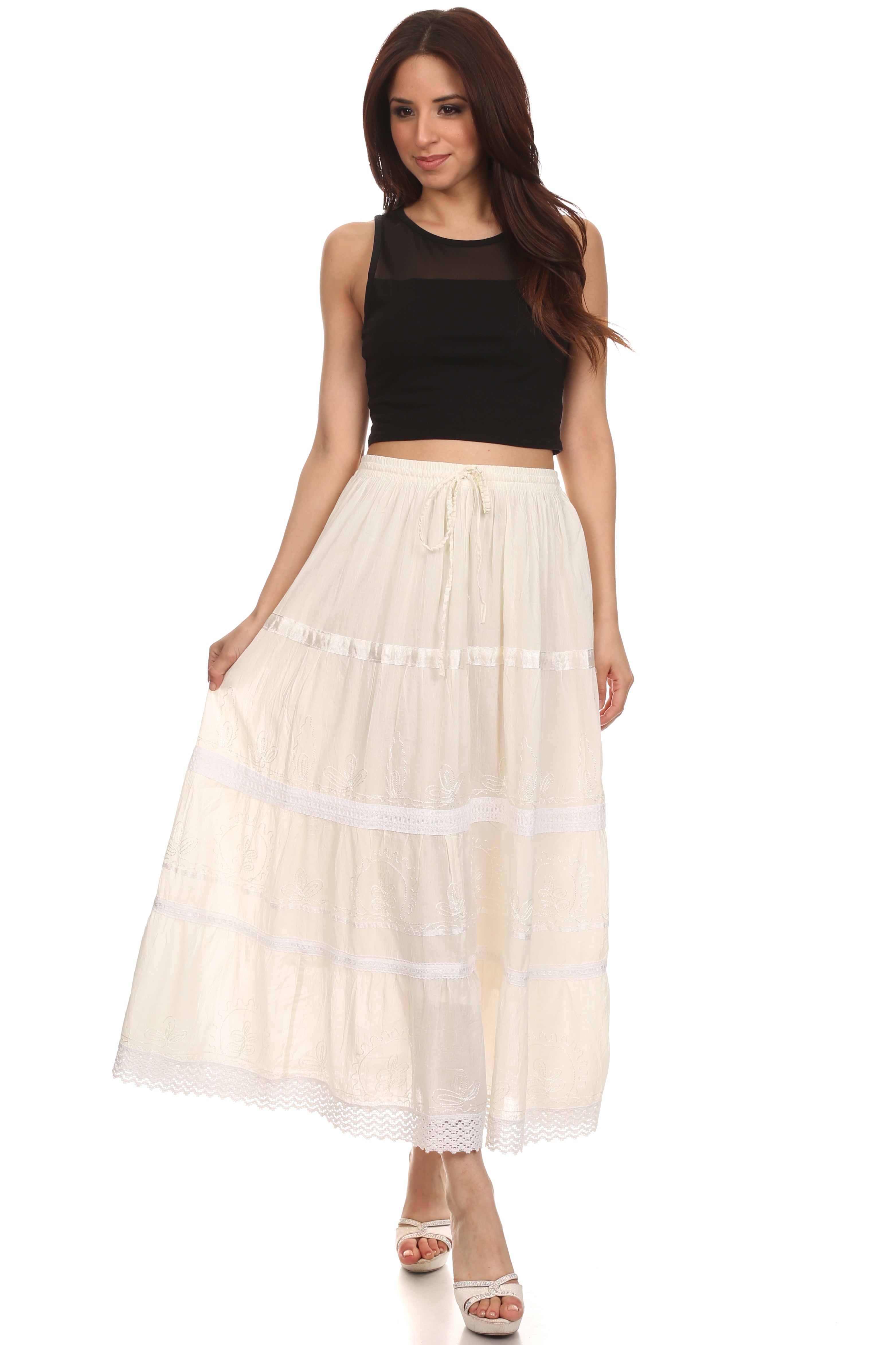 Woman wearing a black top and beige skirt on a white background