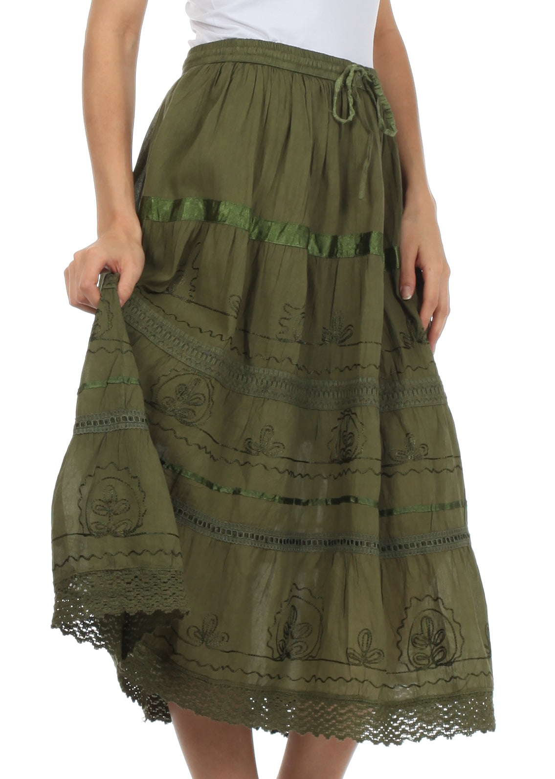 Green embroidered skirt worn by a person on a white background