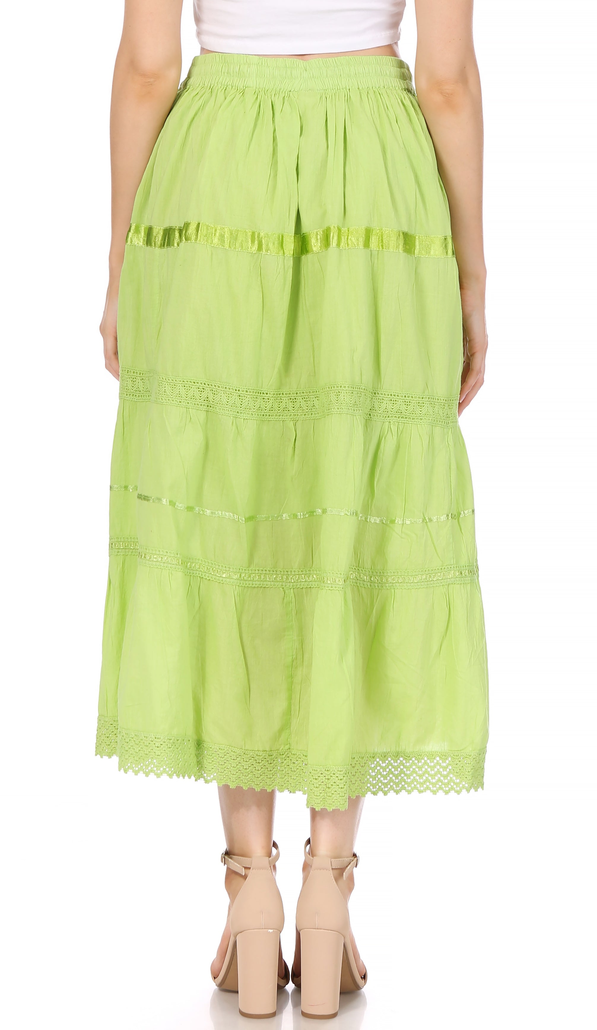 Green skirt with lace details worn by a person on a white background