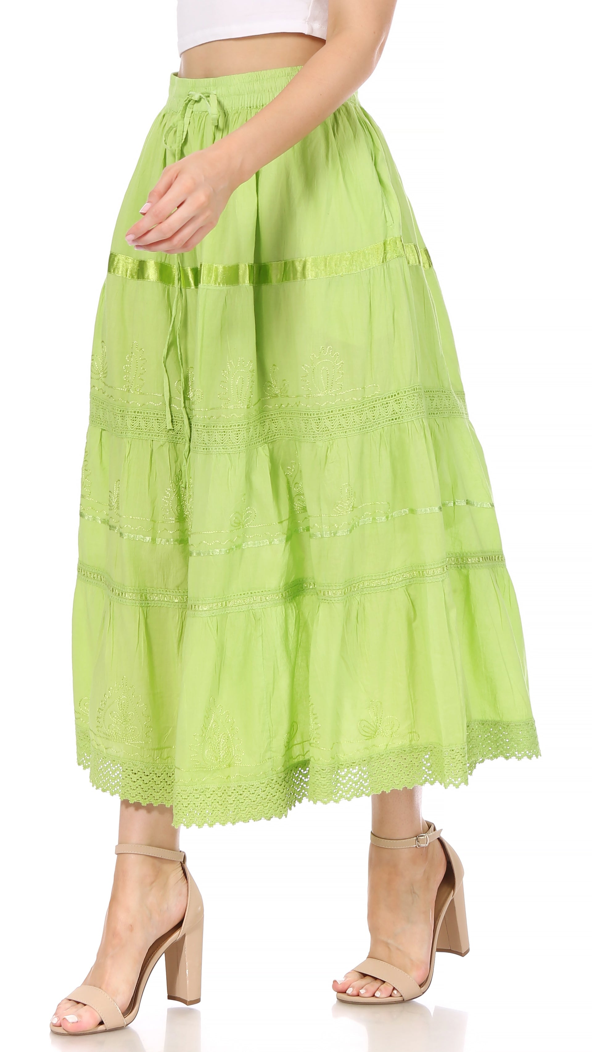 Green tiered skirt worn by a person on a white background