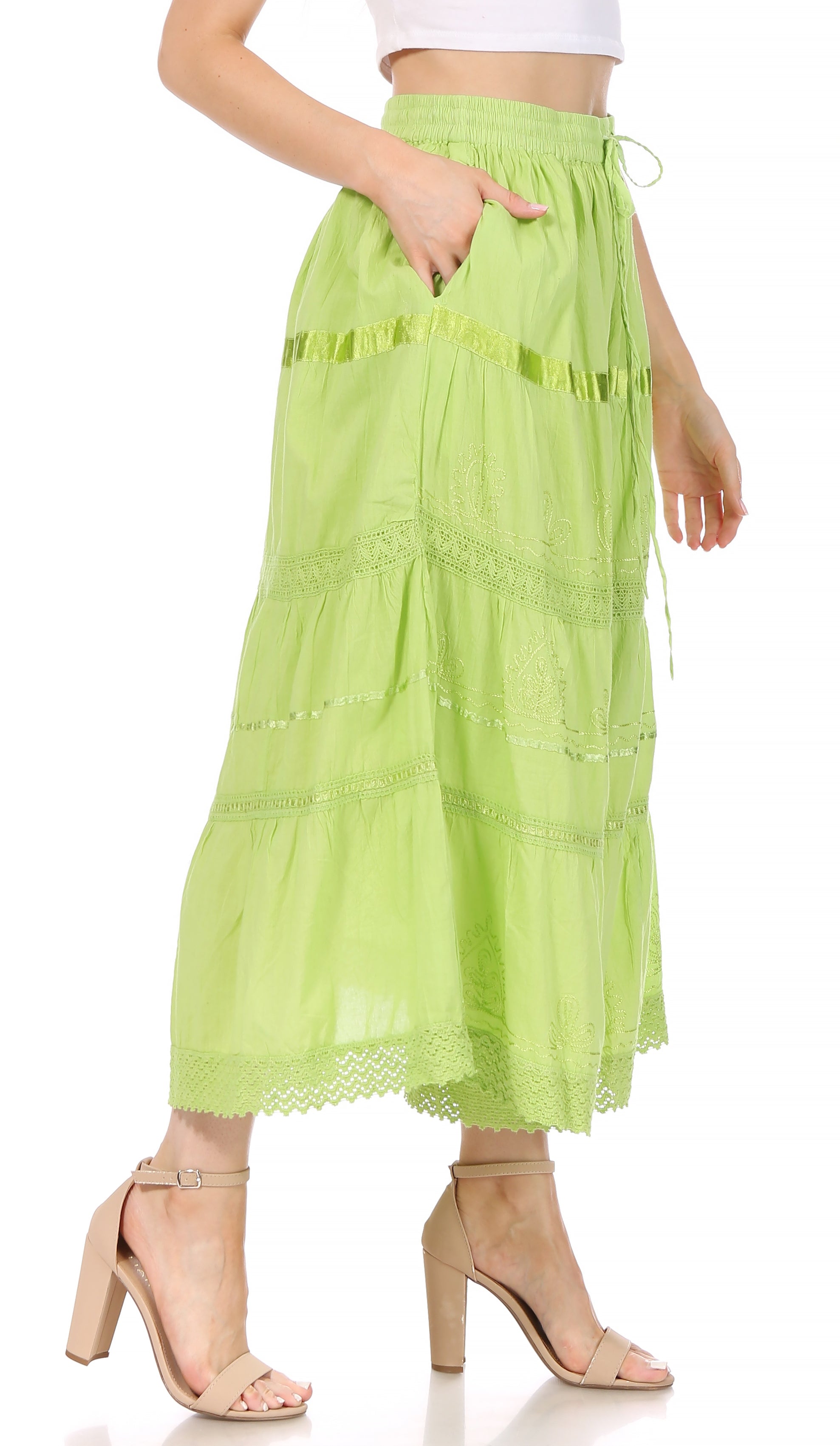 Green tiered skirt worn by a person on a white background