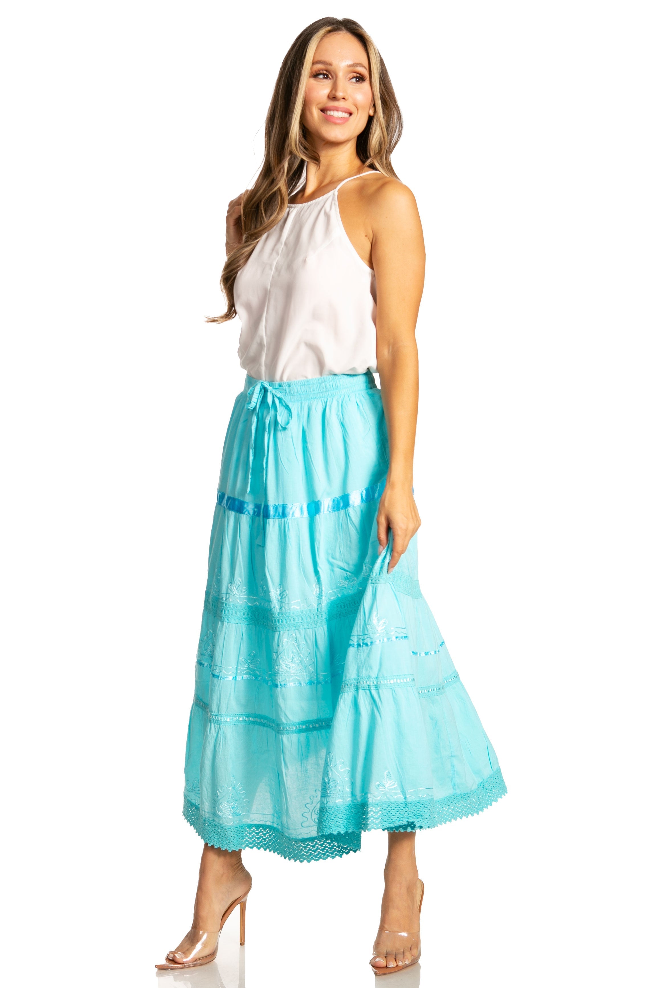 Woman wearing a white top and turquoise skirt on a white background