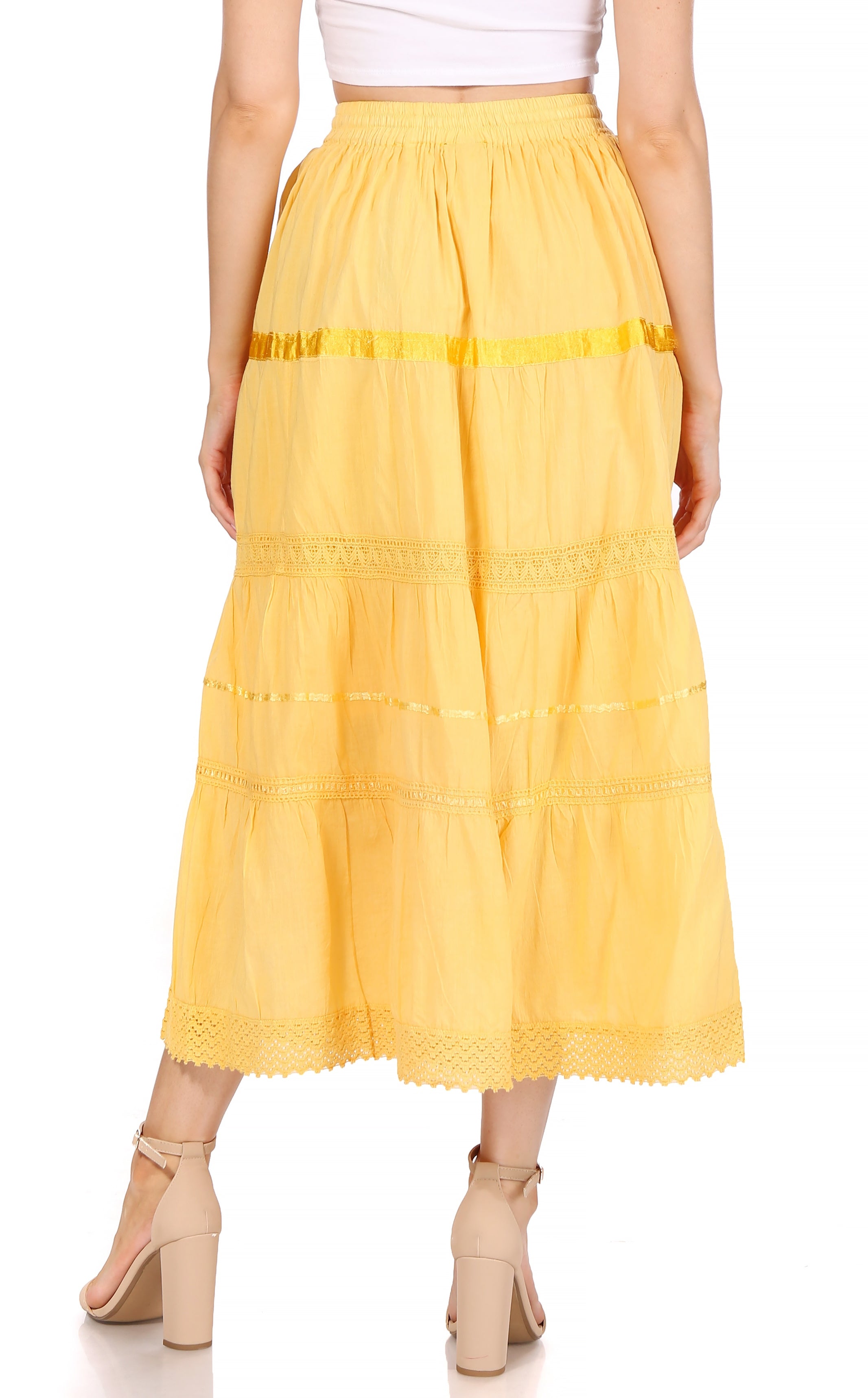 Yellow tiered skirt worn by a person on a white background