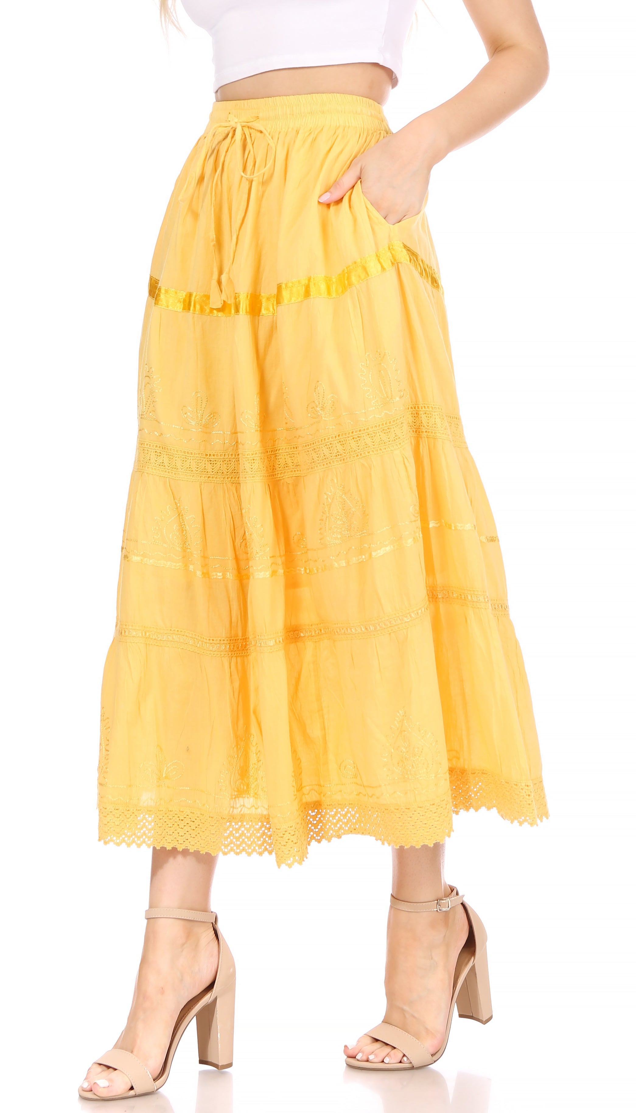 Yellow lace skirt worn by a person on a white background