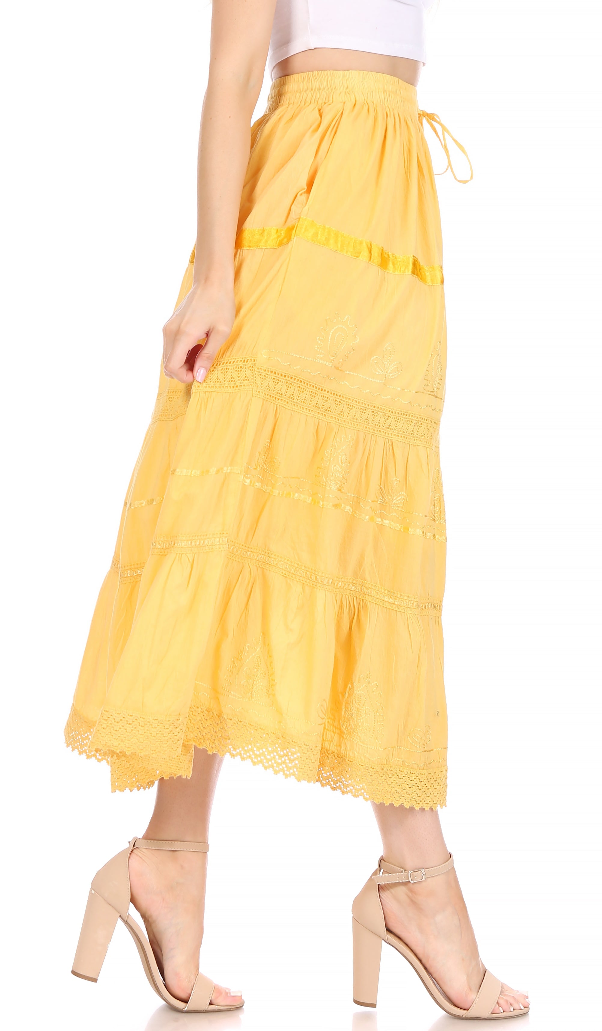 Yellow tiered skirt worn by a person on a white background