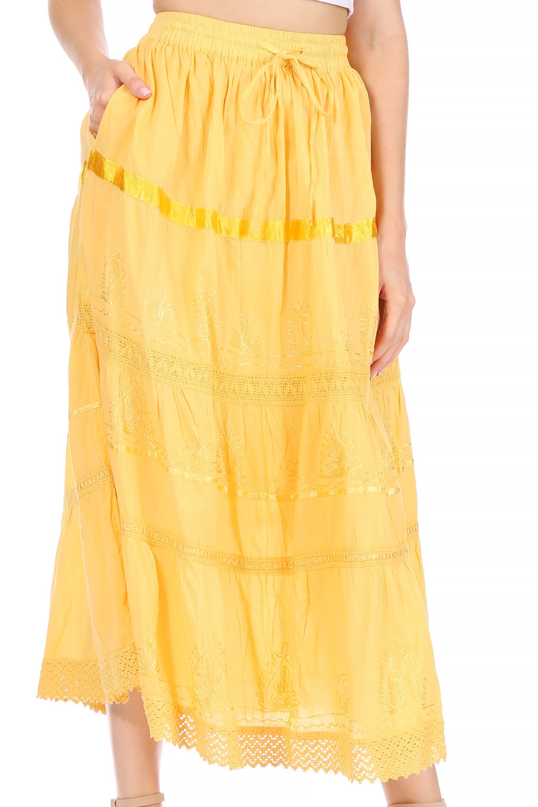 Yellow skirt with lace details worn by a person on a white background