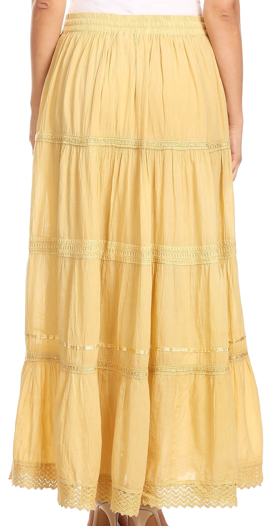 Yellow tiered skirt worn by a person on a white background