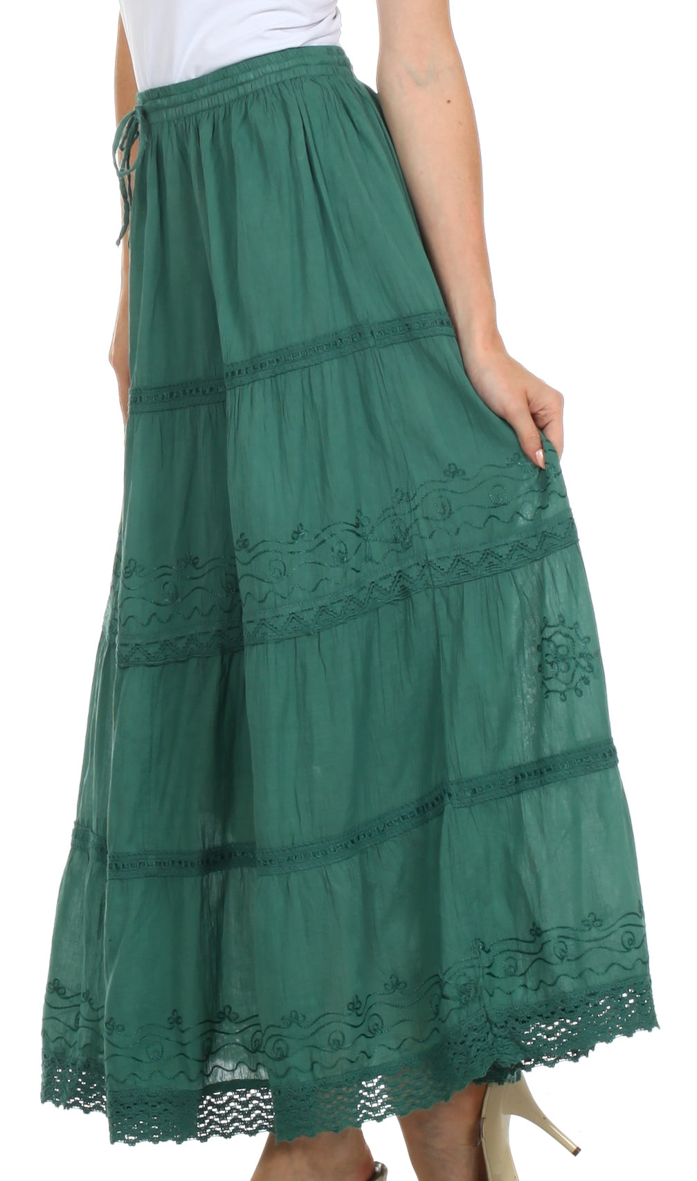 Green lace-trimmed skirt worn by a person on a white background