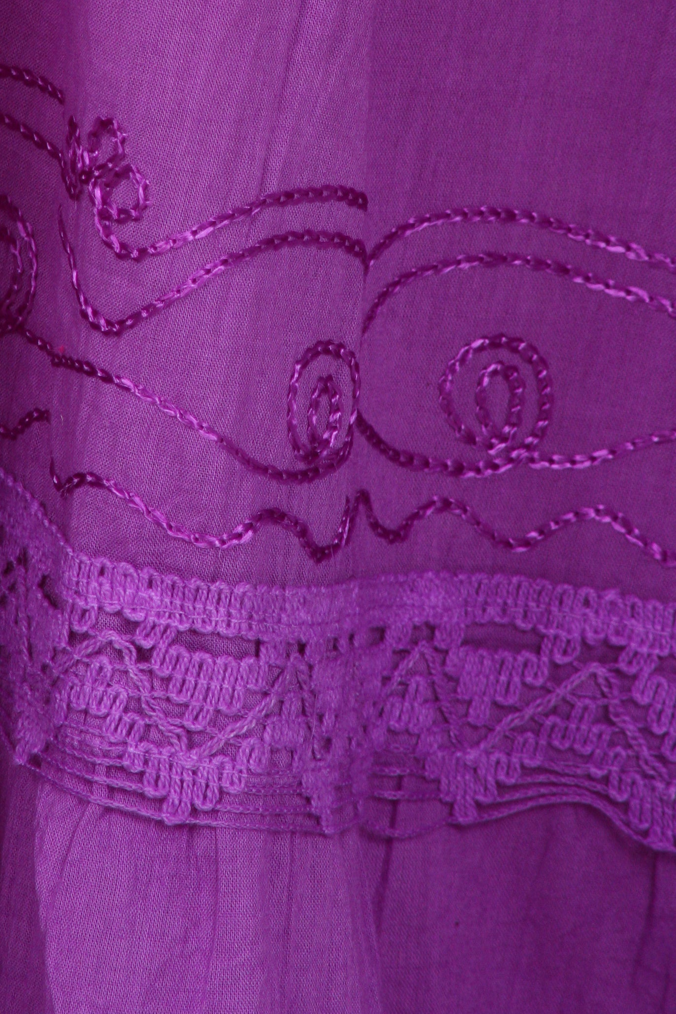 Close-up of a purple dress with intricate lace detailing