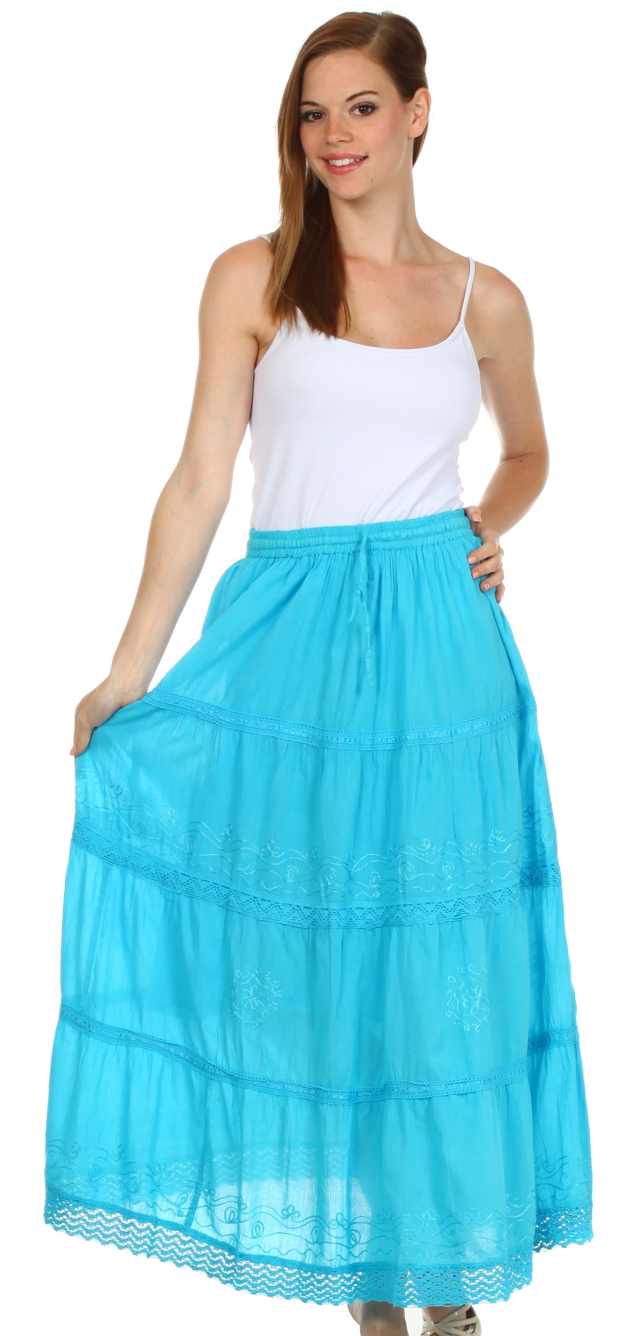Woman wearing a white top and turquoise skirt on a white background